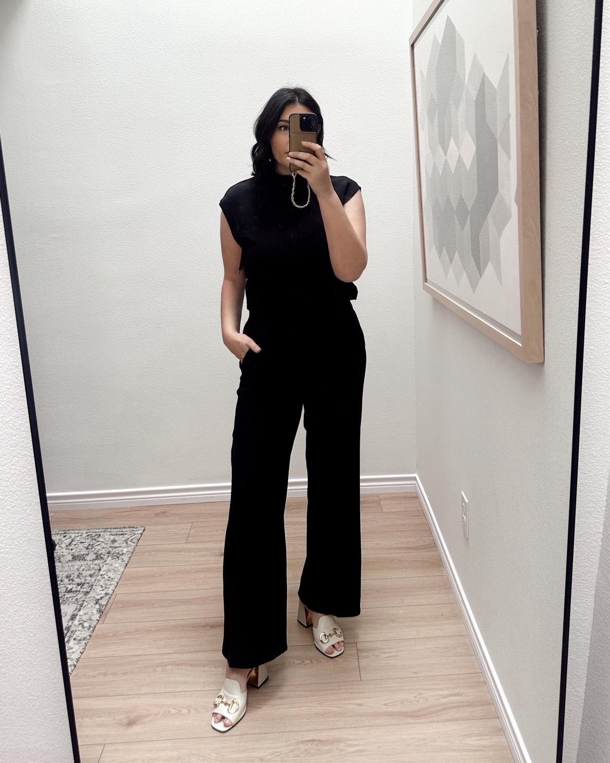 I’m in the medium of this jumpsuit! After reading reviews, I felt it best to stick with my TTS. I do wish I would have gone with the tall  for heels, but with flats or sneakers the regular length is perfect.

Super cute and very comfortable! The fabric is incredibly soft and structured. It has a break in the jumpsuit in the back but it does not show any skin. Easy on and off as far as a jumpsuit goes.  

 
