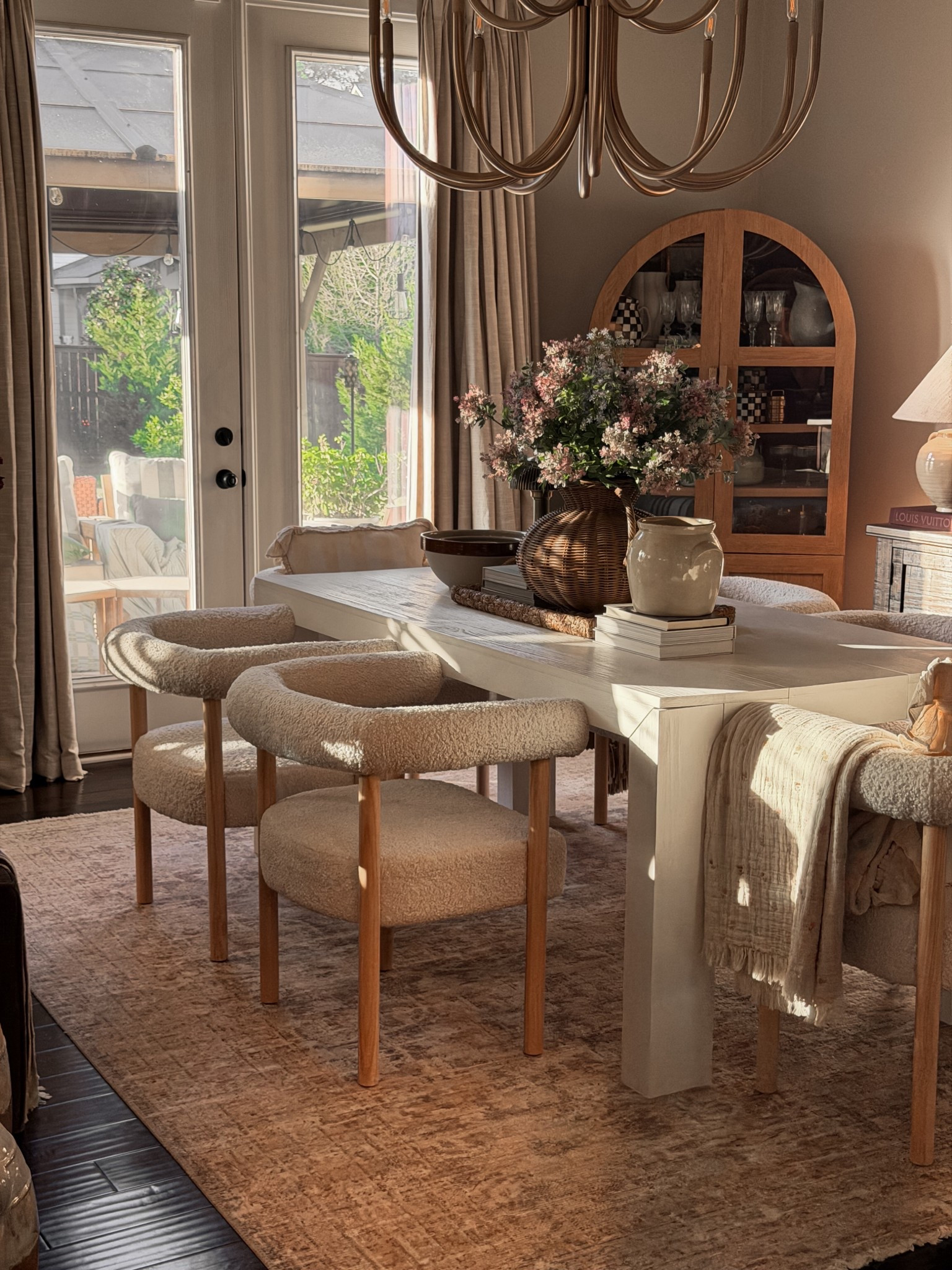 ### **LTK Keywords**
Arched cabinet, Oak hutch, Boucle dining chairs, Sherpa chairs, White dining table, Round wood chandelier, Gold chandelier, Neutral area rug, Textured rug, Linen curtains, Beige drapes, Woven planter, Seagrass basket, Block print throw, Quilted blanket, Stone vase, Ceramic pitcher, Dried florals, Faux stems, European country decor, English cottage style, French provincial dining, Warm minimalism, Organic modern, Earthy tones, Sun-drenched room, Golden hour home, Moody vintage, Neutral aesthetic, Interior styling, Dining room inspiration, Spring home decor, LTK home, LTK find.


#LTKHome