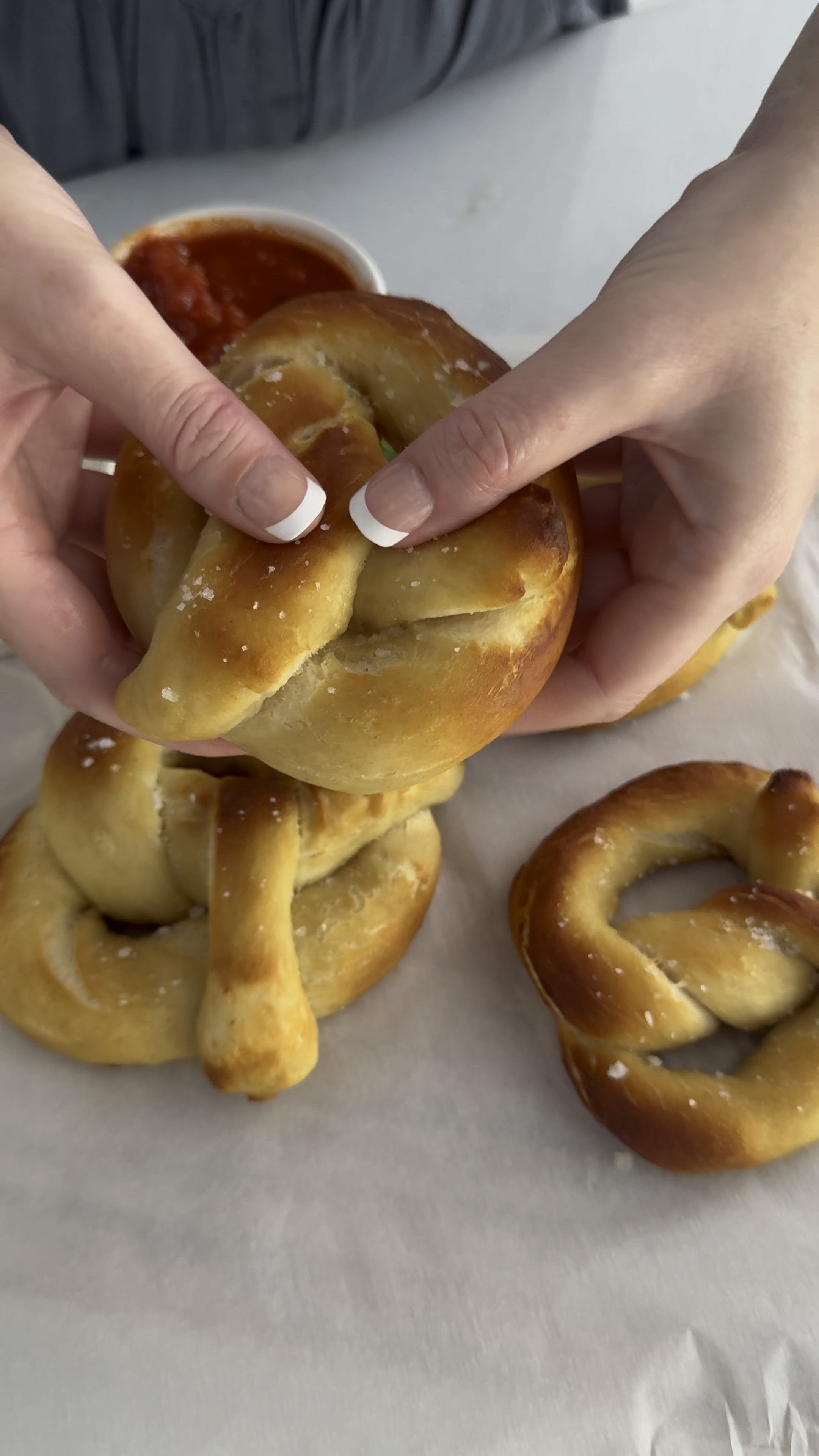 Easy Homemade Pretzels recipe: https://domesticallyblissful.com/easy-homemade-pretzels/ 
Roger loves homemade pretzels, so years ago I did a whole lot of research to come up with an epic recipe Roger would love.
I remembered from years prior (when making them once or twice) that a boiling baking soda bath for the pretzels (before you bake them) is the key step to creating perfect homemade pretzels.
Giving your pretzels a baking soda bath contributes to its signature flavor, beautiful golden crust, and soft chewy interior.
While a baking soda bath truly is the key to a perfectly soft homemade pretzel, I knew from times past that it needed something else to achieve a higher level of pretzel flavor goodness.
So after doing a bunch of research, I decided to add brown sugar to the pretzel dough, I knew this must be the secret ingredient to achieving the best homemade pretzels!
And boy, did these pretzels deliver the most delicious homemade pretzel taste! 
Oh and do you want to know something funny? 
After spending so much time developing just the right recipe and even after making it for years, I’m still a horrible pretzel twister! 
Thankfully, Roger is better at making the classic shape of a pretzel.
So I always have him take over the pretzel twisting job while I dip them in their boiling baking soda water bath and prepare them for baking!
Hey, we all have different talents. Right?
His is twisting the pretzels and mine is eating them!


#LTKHome #LTKVideo #LTKFindsUnder50