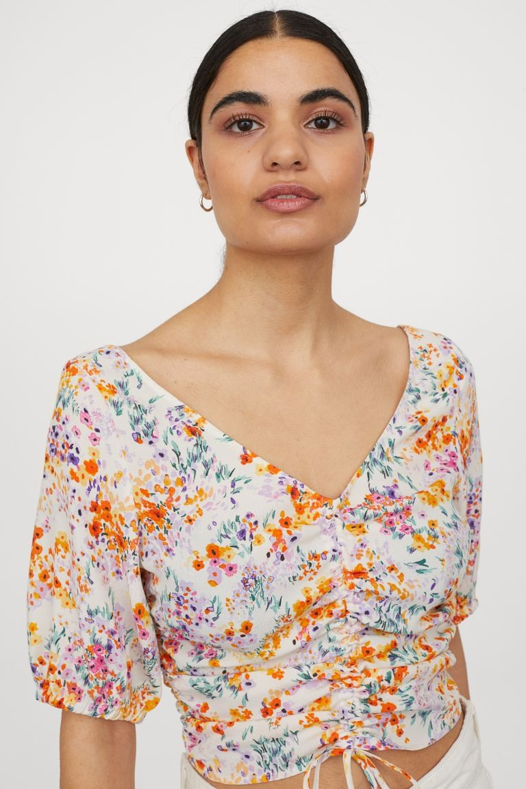 Short, fitted blouse in woven, crêped viscose fabric. Low-cut V-neck at front, vertical drawstri... | H&M (US + CA)