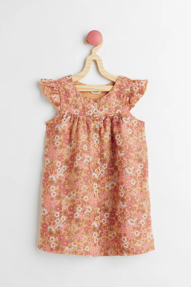 Kids Exclusive. Empire-waist dress in textured, double-weave fabric. Flutter sleeves and buttons ... | H&M (US + CA)