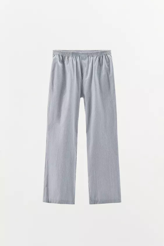 Pyjama-style trousers made of cotton yarn. High waist and elasticated waistband. Side pockets. Wi... | Zara UK