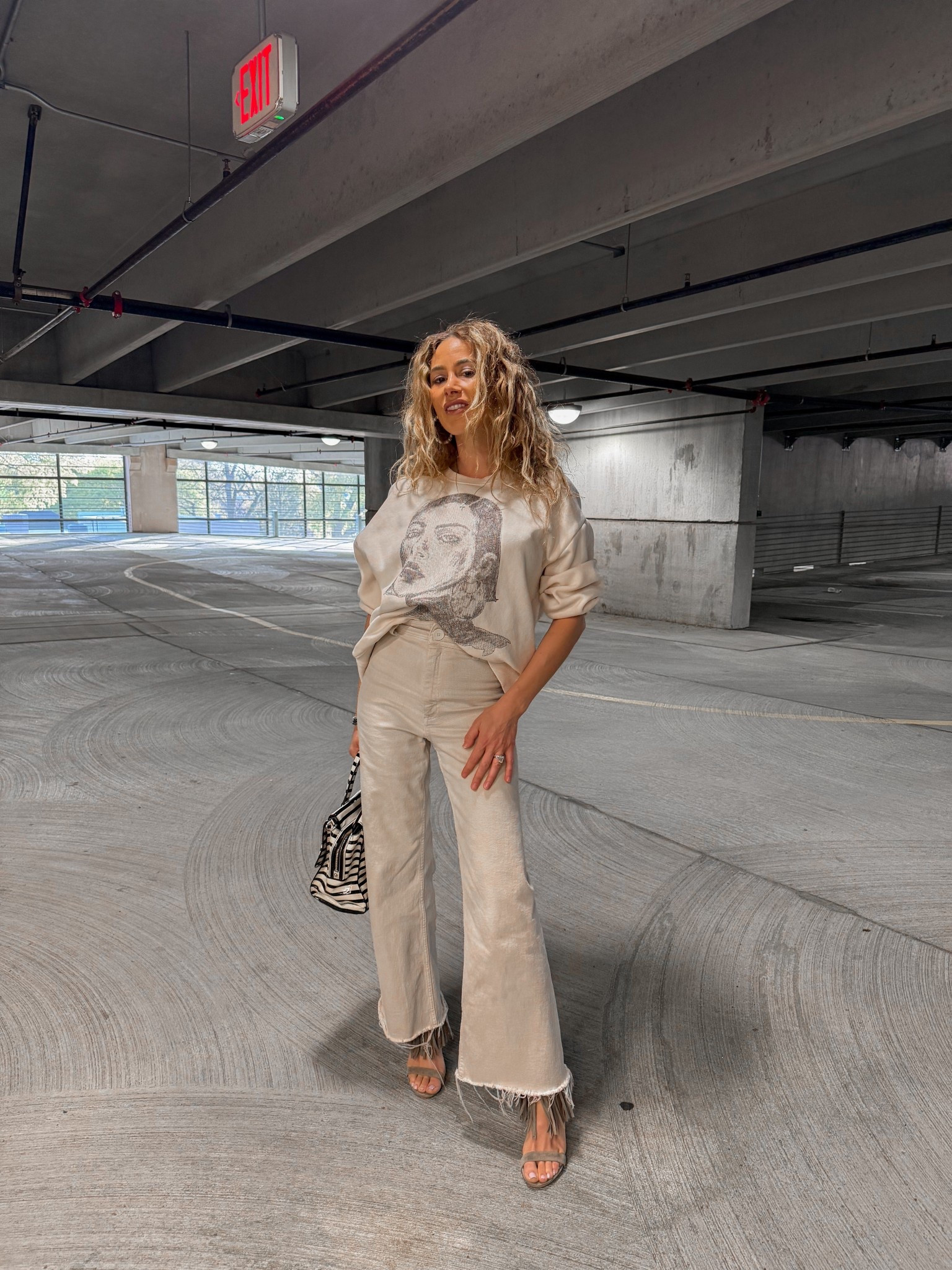 Monochromatic outfit. Outfit of the day. Outfit of the night. Date night. Zara outfit. Neutral graphic sweatshirt. Frayed hem beige denim. Steve Madden gray fringe heels  

#LTKootd #LTKSeasonal