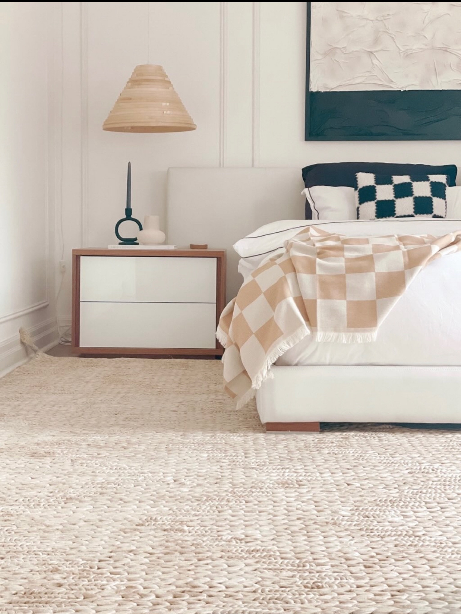 All the details from my primary bedroom, complete with a white upholstered bed with wood vase, neutral area rug, rattan pendant lamp, scandi tapered candle holder, checkered blanket and pillow cases, and modern nightstand  

#LTKhome #LTKunder50 #LTKSeasonal