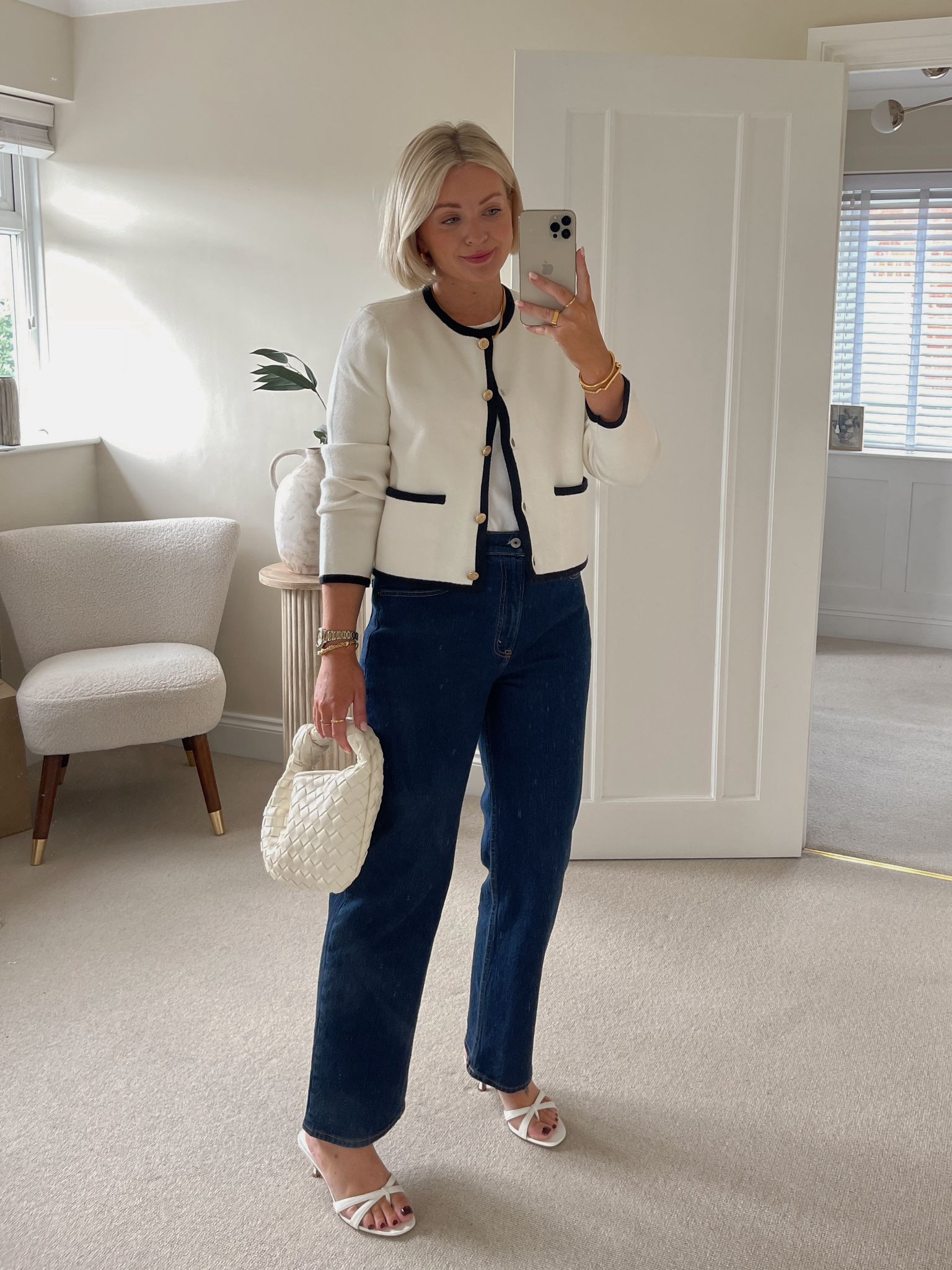 Chic early autumn outfit - dark blue Abercrombie vintage jeans, white cos clean cut t shirt, black & white jacket with gold buttons, white woven knot handbag & mango white strappy sandals

#LTKstyletip #LTKautumn #LTKuk