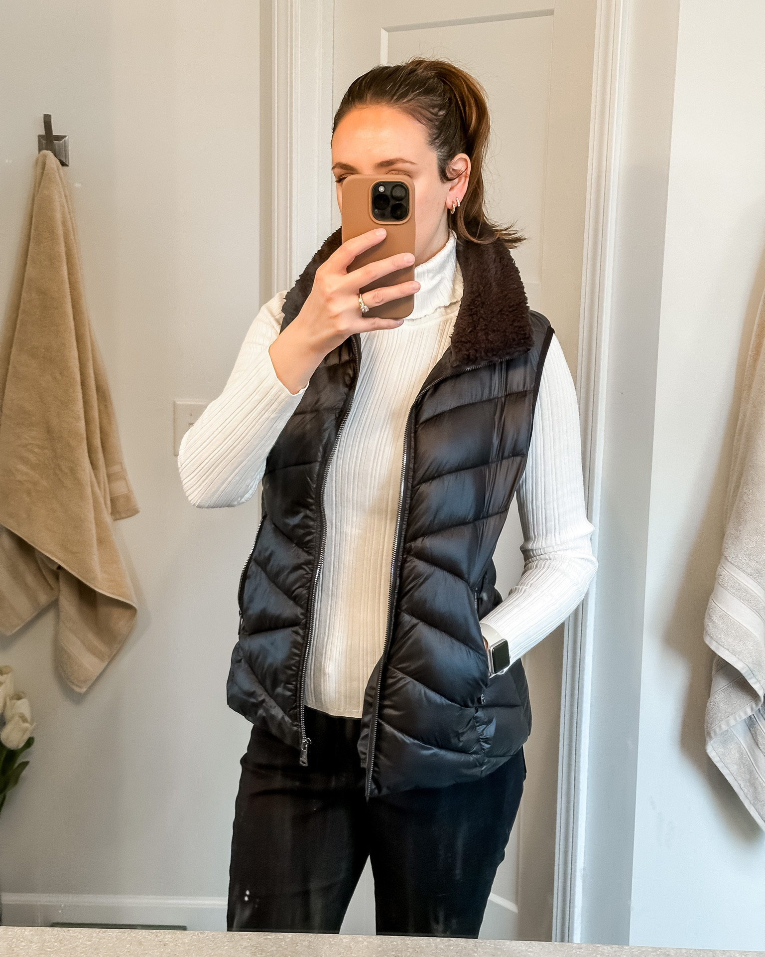 Puffer vest. White turtle neck. Black jeans. Phone case. Black puffer vest. Outfit idea. 

#LTKFind #LTKSeasonal #LTKstyletip