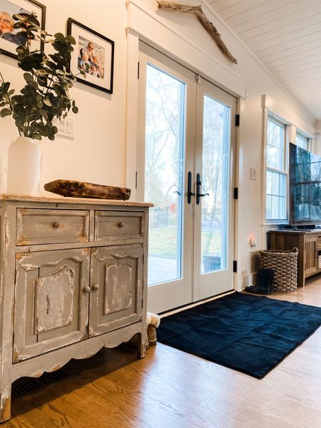 Back entryway refresh. Back door. Black Area rug. Cabinet. Storage. Greenery  distressed. White walls. Shoe Basket

#LTKstyletip #LTKFind #LTKhome