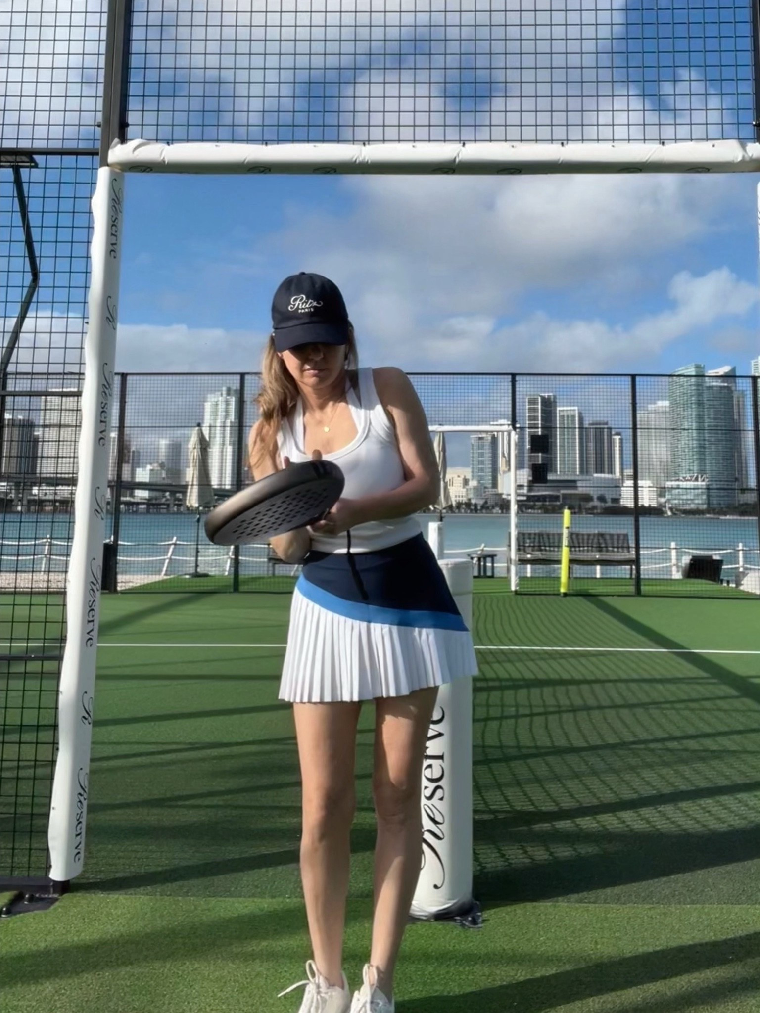Me on the Padel court. Wearing my Frame Denim x Ritz baseball hat in navy, white sports bra and tank, my Wilson Padel racquet + a retro style color blocked tennis skirt. (Mine is from Penguin, similar styles linked)

Tennis outfit, padel outfit, pickleball outfit, activewear outfit, athleisure outfit

#LTKootd #LTKActive #LTKfitnessgoals