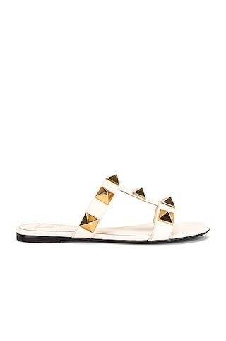 Valentino Garavani Roman Stud Slides in Ivory | FWRD 