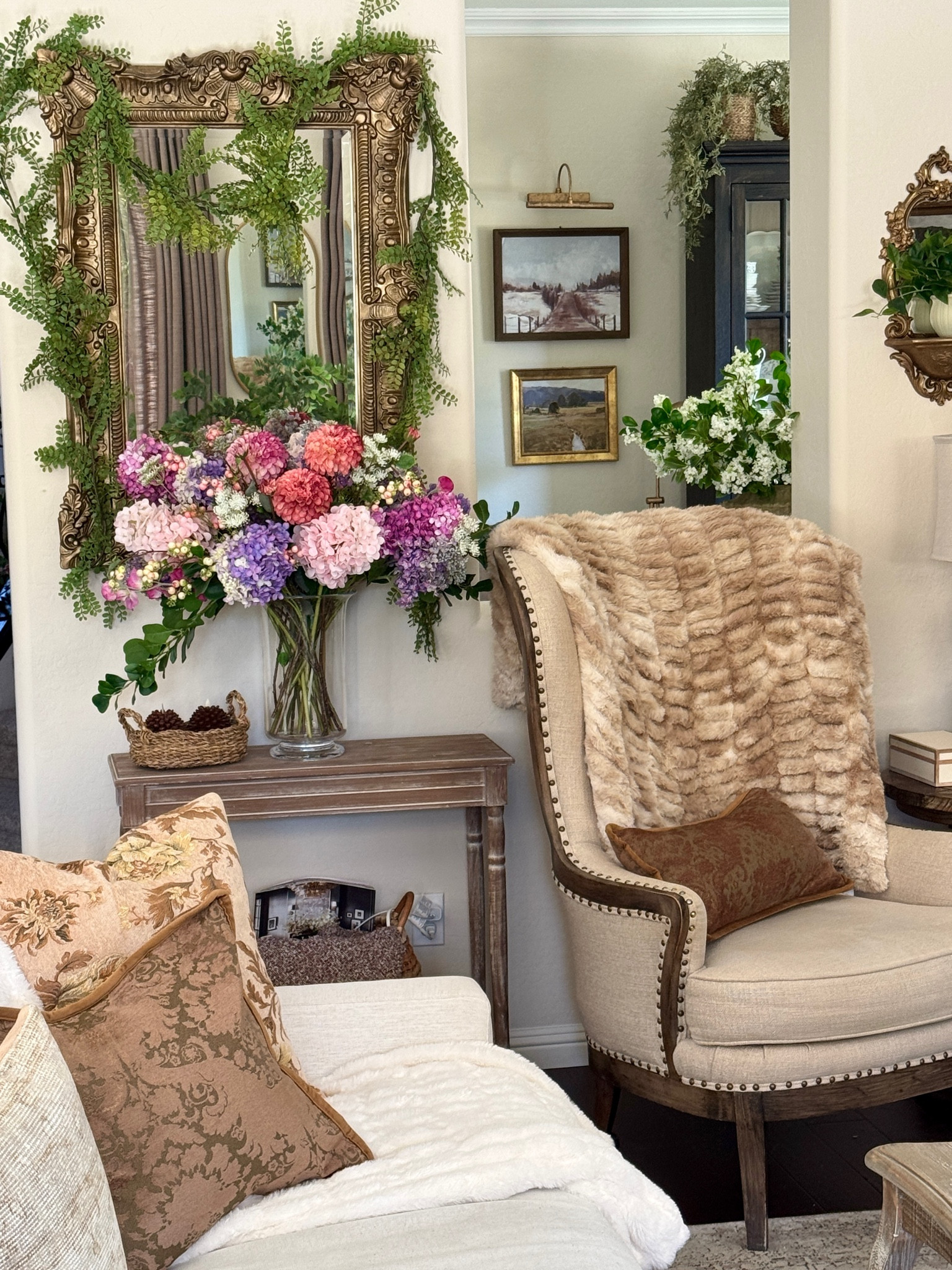 Some items from this section of my living room 🩷

French gold mirror, faux florals, faux fur throws, vintage tapestry pillows, hydrangea, dahlia, lilac, sweet pea

#LTKHome