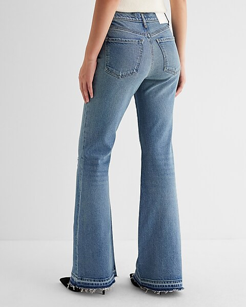 Mid Rise Medium Wash Raw Drop Hem '70s Flare Jeans | Express