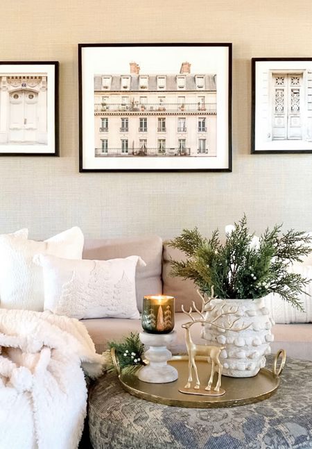 Early Christmas, holiday styling. Best selling brass reindeer available in 3 sizes and a bronze finish, Minka vase, greenery stems, soft and cozy throw blanket and pillows, fragrant holiday candles, brass metal tray, neutral sofa, Parisian artwork , living room styling. 

#LTKhome #LTKsalealert #LTKHoliday