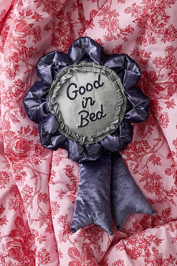 Trophy Ribbon Shape Velvet Throw Pillow in Good In Bed at Urban Outfitters | Urban Outfitters (US and RoW)