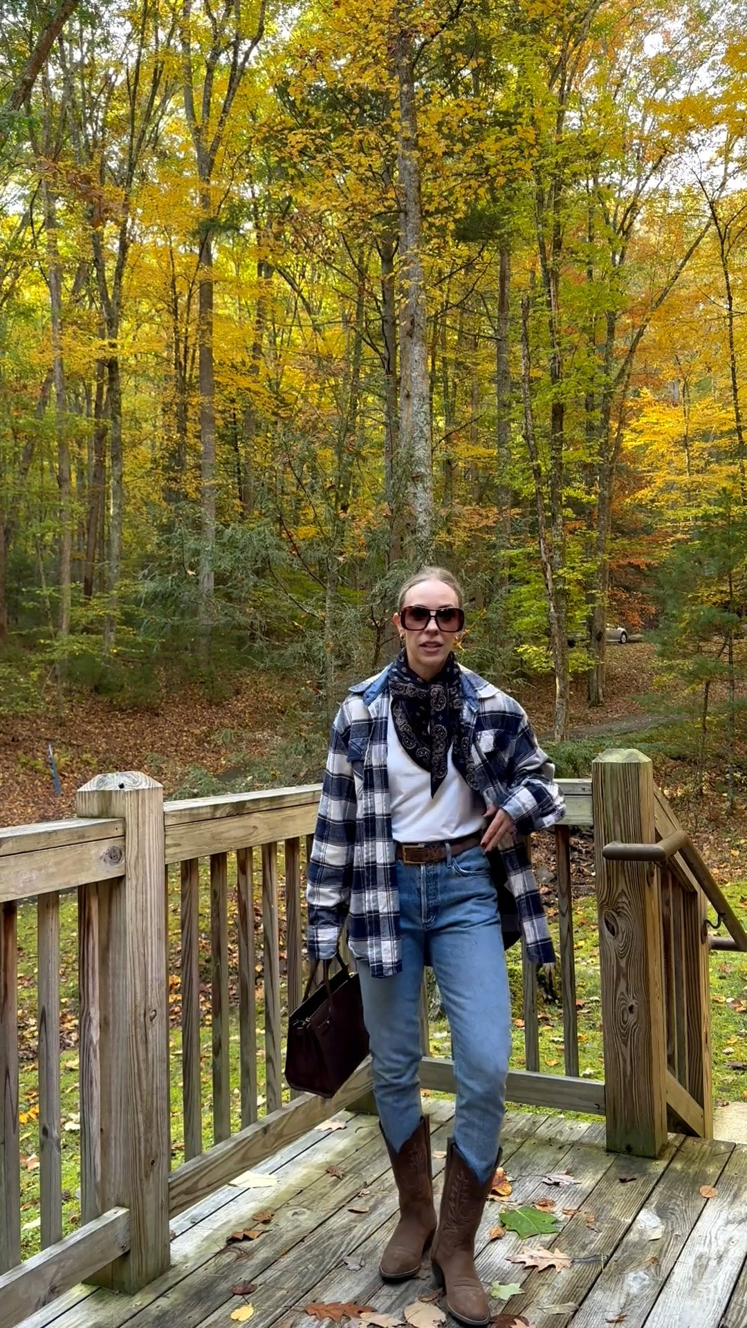 Casual fall travel outfit with flannel shirt, @Guest In Residence bandana print scarf, Ariat cowboy boots