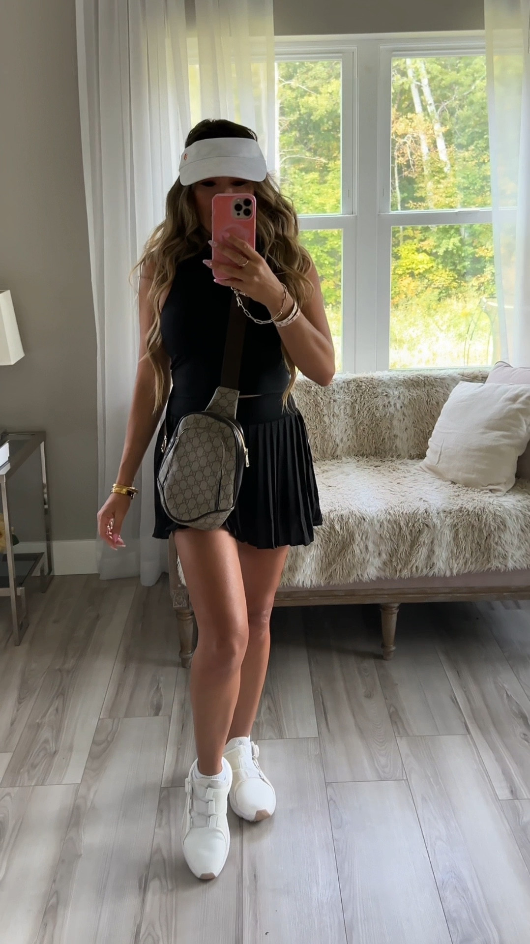 I'm so excited to share my latest look for a company golf outing 🌟. I'm rocking a chic tannish tennis skirt paired with a sleek black tank top. Love how the skirt has built-in shorts and the top features a built-in bra – super comfy and stylish for a day on the course! ⛳️ Casual fall outfits, all black outfit, simple outfit idea, casual chic style  

Perfect outfit for blending sporty and fashionable vibes. Let me know what you think! #GolfFashion #OOTD #FashionInspo

#LTKFitness #LTKSeasonal #LTKActive