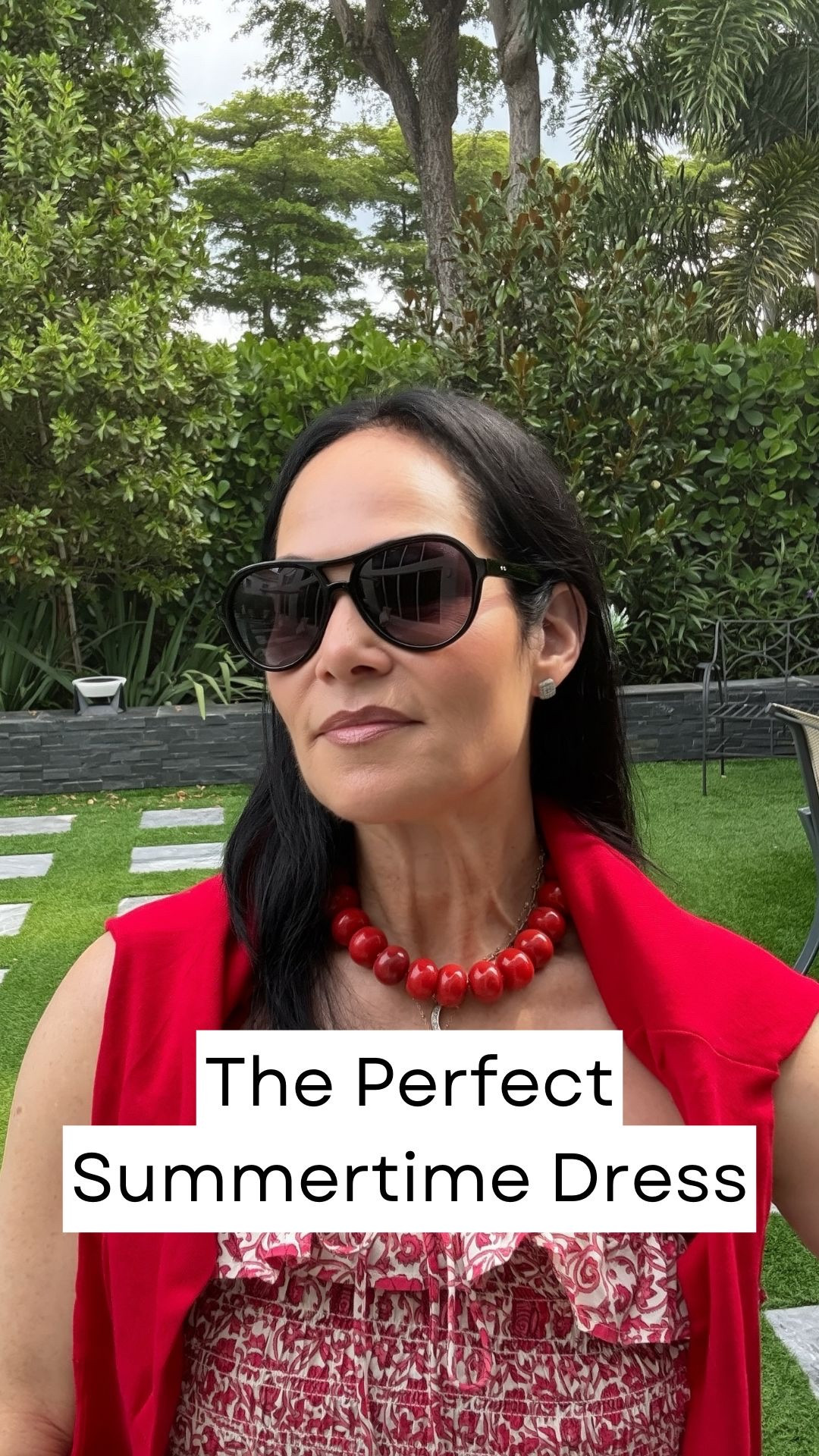 Today’s look is giving easy summer style with a feminine twist ❤️☀️

I’m wearing this beautiful red patterned dress and it’s one of those pieces that feels as good as it looks—lightweight, breezy, and perfect for those hot summer days.

What I love about this dress is all the little details:
✨ Pretty smocking at the top
✨ A faux tie detail
✨ Soft dainty ruffles
✨ A defined waist for shape
✨ And yes… pockets (which always makes me happy 👏)

This is the kind of dress that’s so versatile—you could easily throw it on over a bathing suit for vacation, wear it walking around town, or dress it up for lunch or dinner.

I paired it with my jelly sandals with the pearl detail—if you’ve been following me, you know I’ve worn these on repeat because they’re cute and comfortable.

And because if you know me, you know this is true… I am cold everywhere I go 🥶😂
So I added a cardigan over my shoulders because aggressive air conditioning and I are not friends—especially when traveling.

Finished the look with:
👜 A tan bag
🕶️ Sunglasses
📿 One of my favorite bead necklaces (I own these in multiple colors!)

This is exactly the kind of summer dressing I love—comfortable, chic, and intentionally put together without trying too hard.

Would you wear this? ❤️

#LTKootd #LTKgrwm #LTKdayinmylife