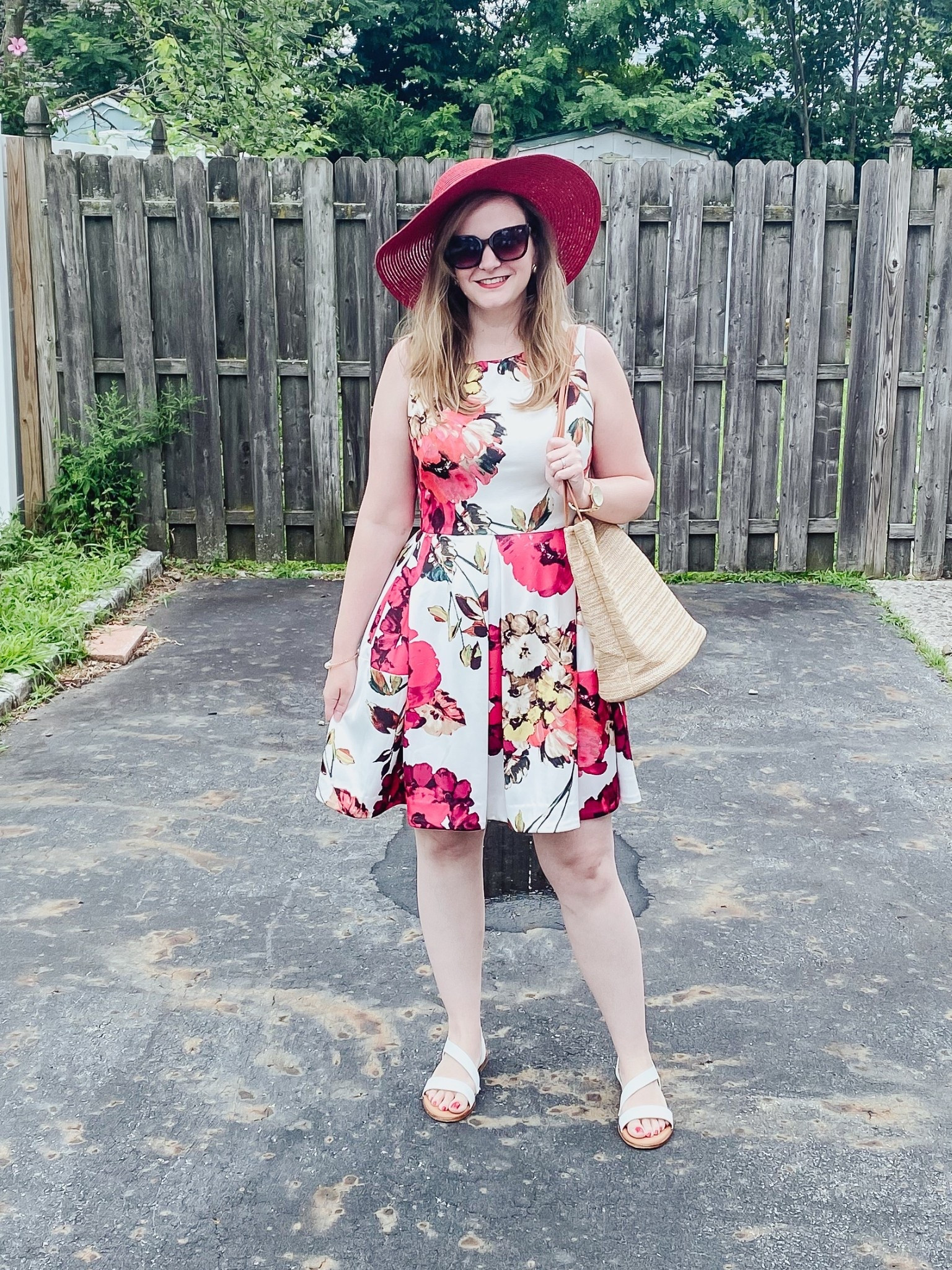 Red straw hat 
Straw bag 
White and red floral dress 