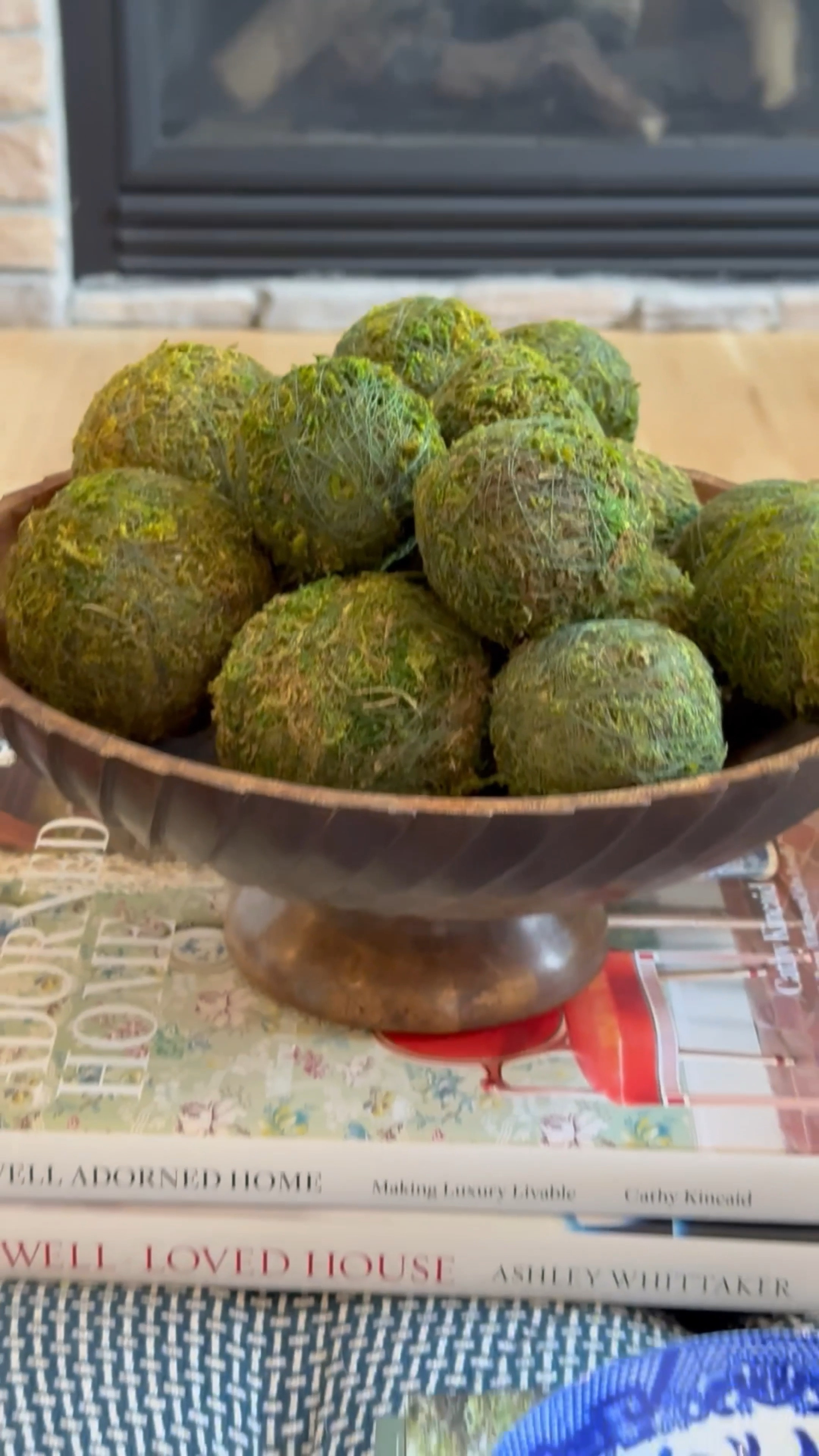 Shop my coffee table!  I love the simplicity of using moss balls or faux artichokes (or green apples!) in this pretty wooden bowl. The burl wood box adds a nice touch and I love my coffee table books!!  Living room. Coffee table. Decorate  

#LTKVideo #LTKHome #LTKSummerSales