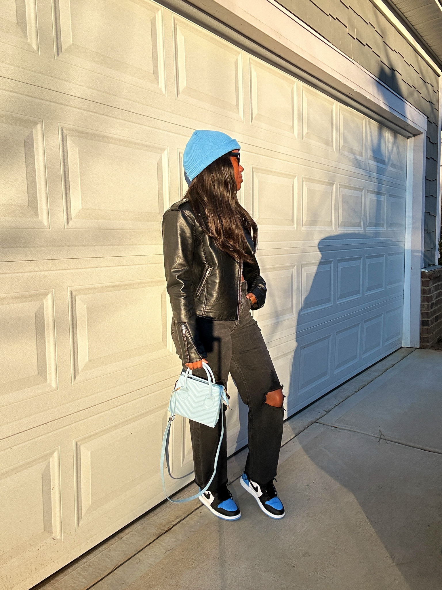 How to style a black faux leather jacket with black jeans, black crop top, blue beanie, blue purse, and Jordan 1 UNC toe sneakers

#LTKStyleTip #LTKShoeCrush #LTKFindsUnder100