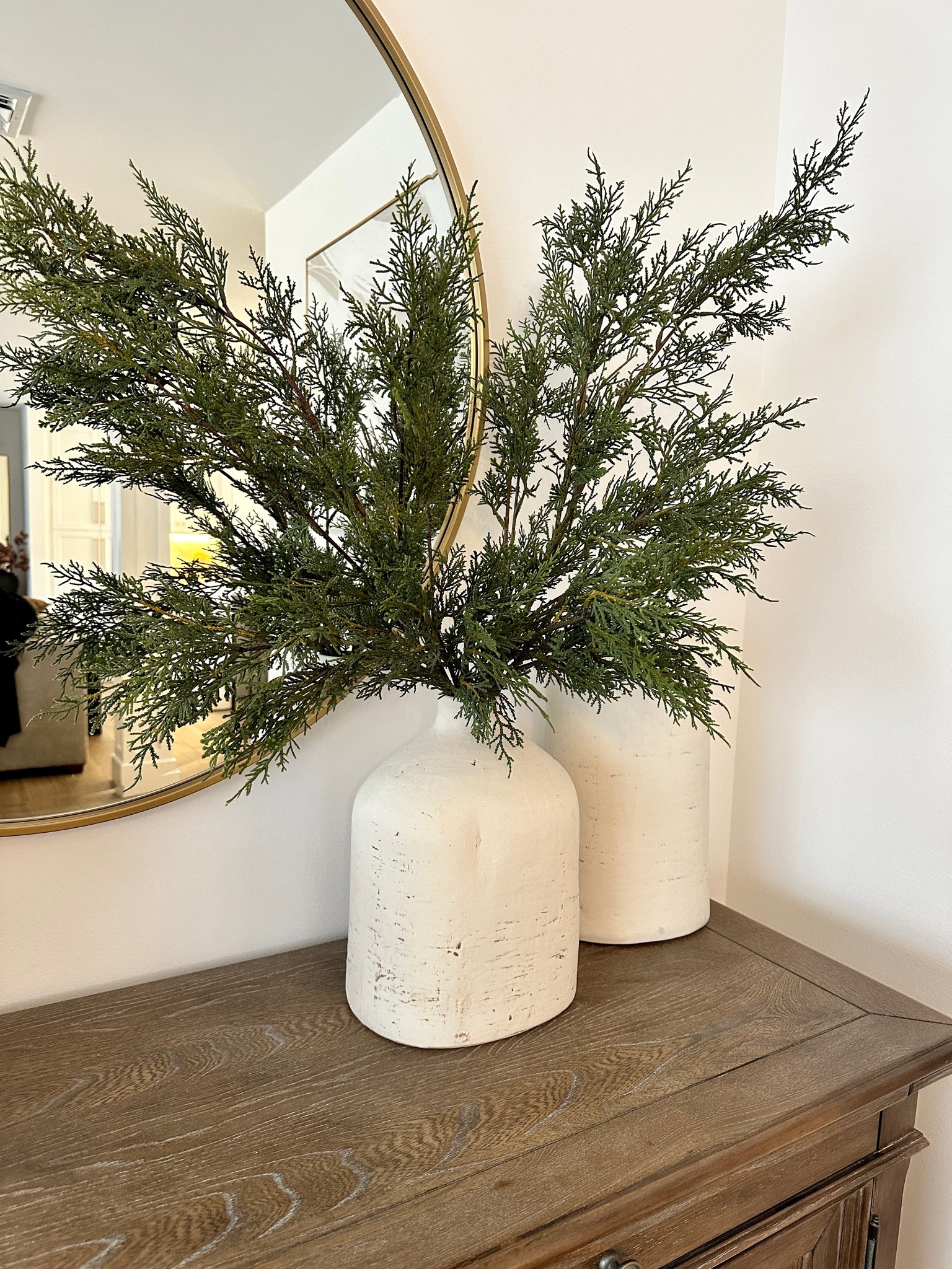 Cedar stems, white vases, bar wood sideboard, buffet table, gold round mirror, holiday decor, Christmas decor, dining room

#LTKbaby #LTKhome