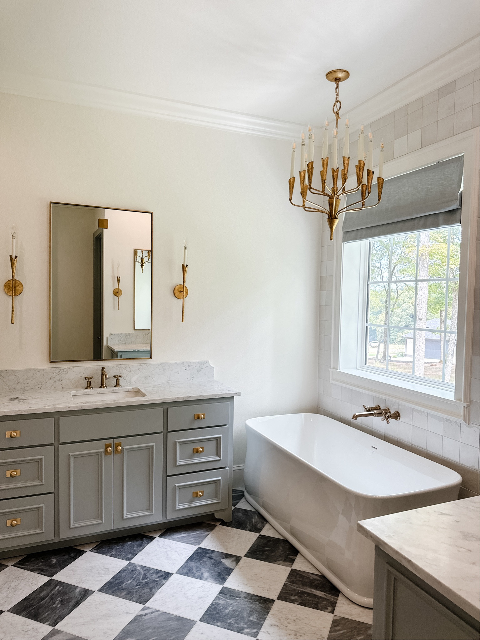 Bathroom lighting / brass light / chandelier / bathroom sconces / bathroom chandelier / gold faucet / brass faucet / modern lighting / transitional lighting 

#LTKHome #LTKStyleTip