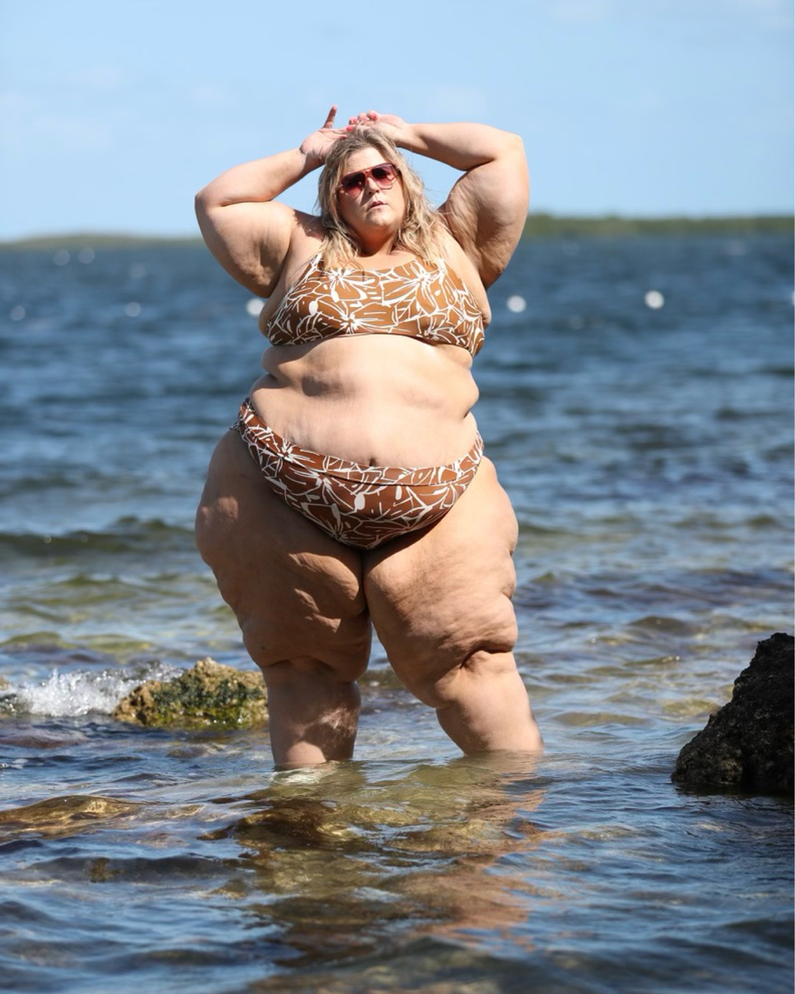 I love rocking this brown and white floral print bikini paired with brown sunglasses. The bikini features a flattering cut that accentuates curves while providing comfortable coverage. The brown sunglasses add a touch of sophistication to the overall look, making it perfect for lounging by the pool or soaking up the sun on the beach. Whether you're a fan of floral prints or looking for a chic and trendy bikini for the summer, this outfit is sure to make you feel confident and stylish.  #plussizeswimwear
#plussizebikini
#curvyswimwear
#beachbodypositive
#bodypositivity
#honormycurves
#swimsuitsforall
#celebratemysize
#effyourbeautystandards
#plusbodiesarebeautiful

#LTKswim #LTKcurves #LTKSeasonal