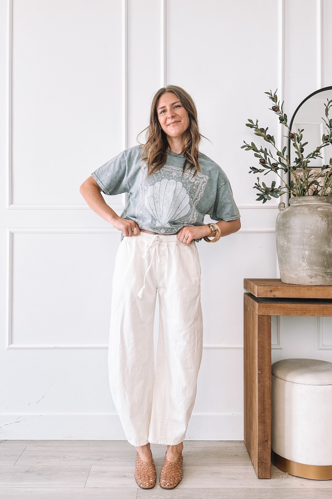Sage green shell graphic tee with cream white linen pants, studded mules and gold bangles. Wearing a large in the tee. I am 5’8” and typically a small so size up at least two sizes for an oversized fit. All pieces linked here.

#LTKootd #LTKmomlife #LTKgrwm