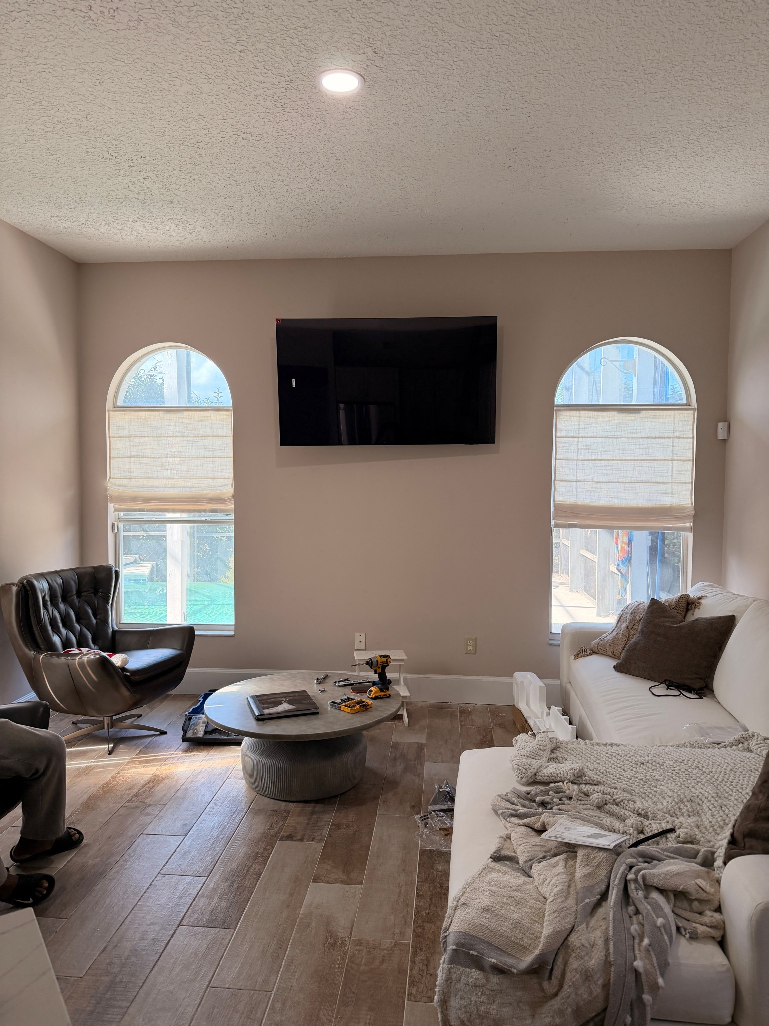 Ya’ll look what my husband did to me 😭 Why in the hell does he think this tv should be this high? Jesus take the wheel.

Leather chairs are in the color burnished wolf gray. Paint color is Sherwin Williams Touch of Sand.

#maritalproblems #homedecor #familyroom

#LTKdayinmylife #LTKHome #LTKstorytime