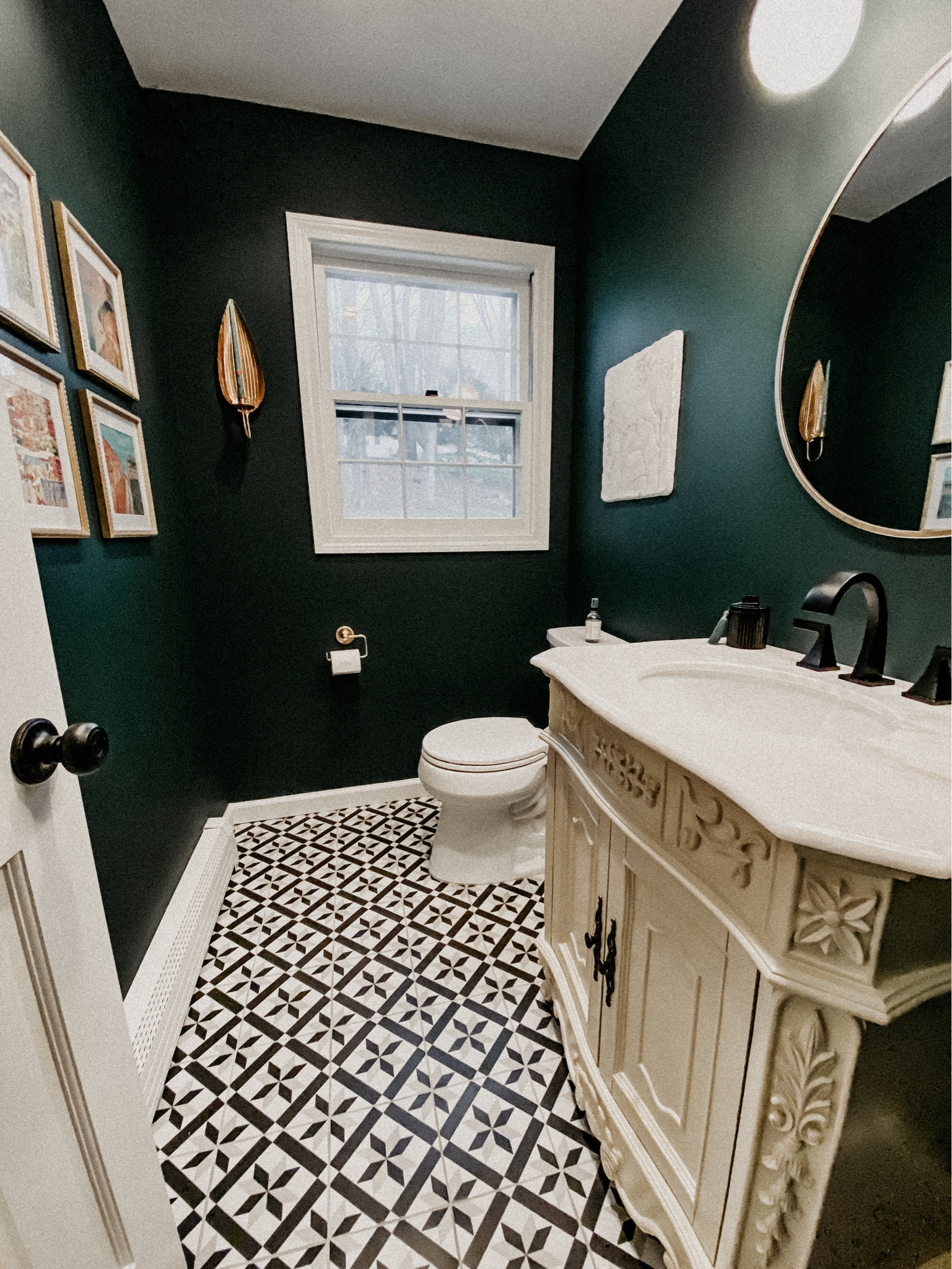 Powder room half bath bathroom styling and decor! Bold black and white neutral print tiles, stunning statement vanity cabinet, gold hardware and accents. Deep dark green painted walls. 

#LTKstyletip #LTKfamily #LTKhome
