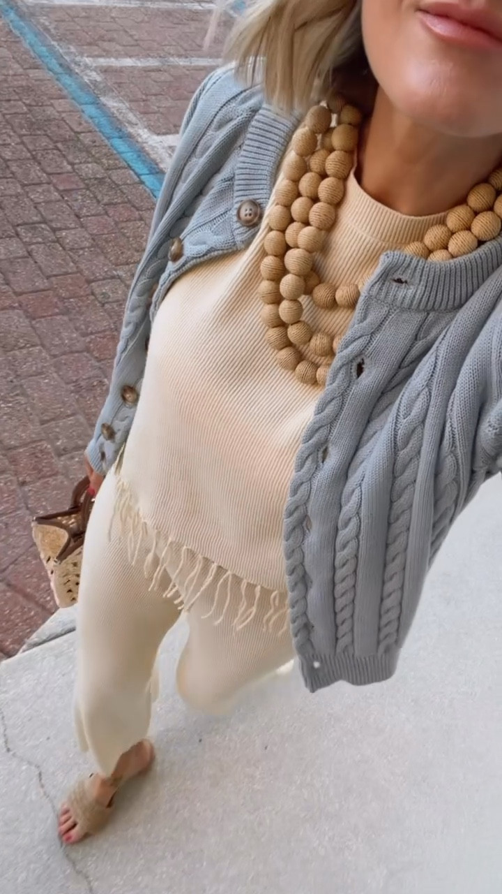 Obsessed with this look! This dusty blue cable cardigan with this lightweight set is perfect for these warmer days and temperature changes in the evening! Super beachy and perfect for vacation. Wearing size S in everything 

Loverly grey, raffia statement necklace, chunky jewelry outfit ideas, resort wear inspo, matching set for women, summer spring fashion 2026

#LTKootd #LTKTravel #LTKSeasonal