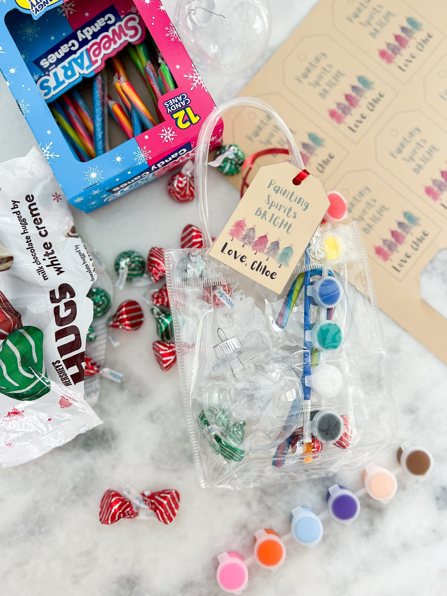 Looking for a class Christmas party gift/treat idea? Check out this cute DIY Ornament painting treat bag! Add a plastic ornament with a painting set, a few pieces of Christmas candy, and voila! Created a cute printable off of Canva, and tied the gift bag onto the reusable gift bag with red ribbon. 

#LTKHoliday #LTKParties #LTKGiftGuide
