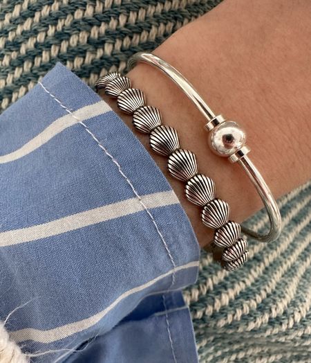 Cape cod screwball bracelet. I bought mine secondhand at thrift store on cape cod. I’ve linked similar options. Some are from Eden Hand Arts and others are from Le Stage. I’ve also tried to link similar shell bracelets 