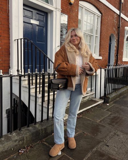 brown/tan aviator faux fur shearling oversized jacket, cable knit ralph lauren sweater, straight leg mid rise light wash jeans and chestnut ugg ultra mini boots for a cosy winter outfit  

#LTKSeasonal #LTKstyletip #LTKeurope