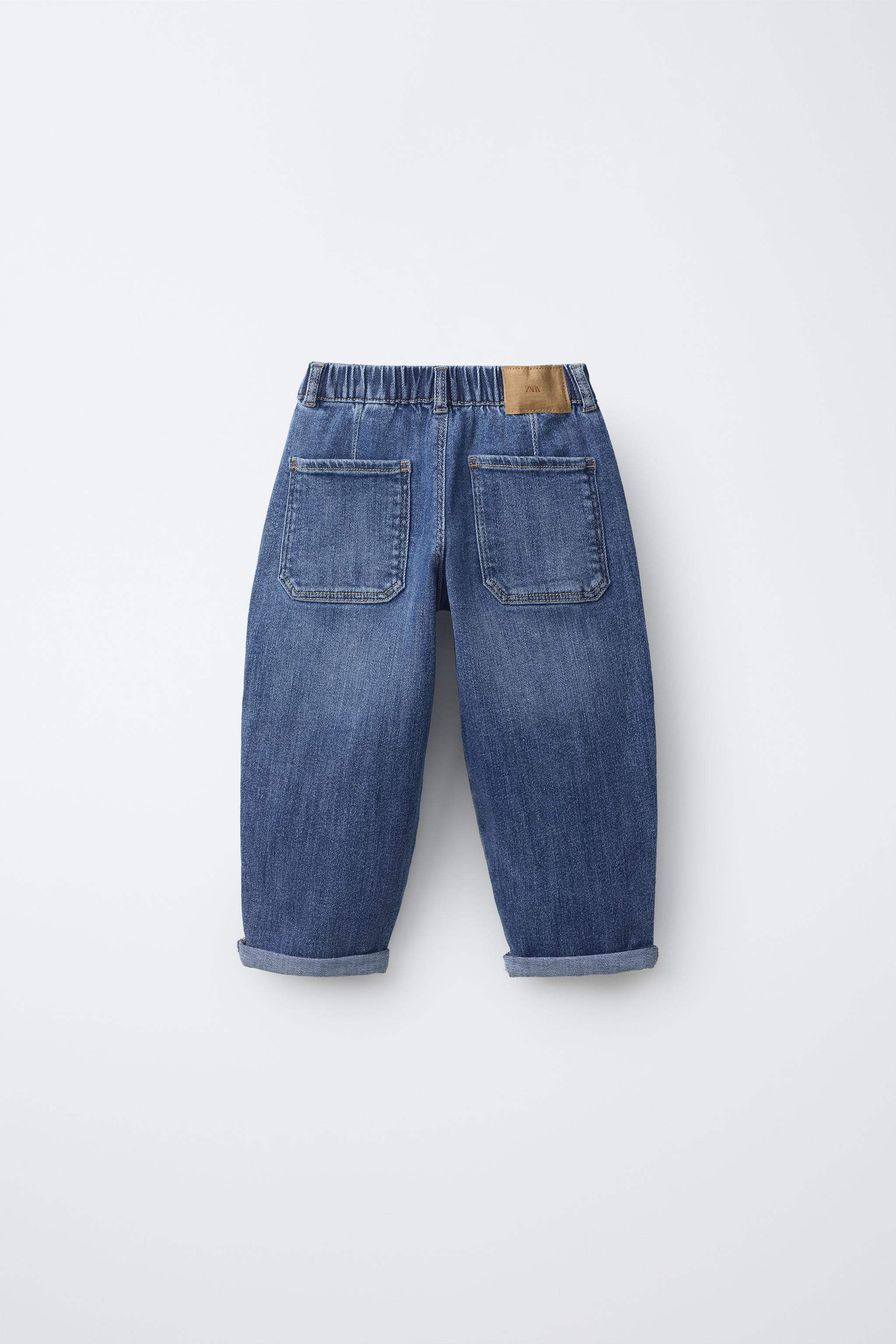 Baggy jeans with an elastic waistband and front snap-button closure. Front pockets and back patch... | Zara US