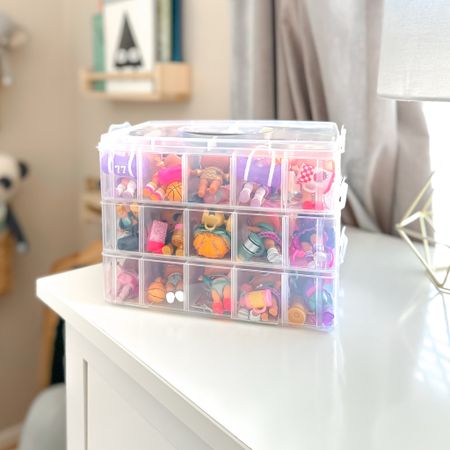 This is the best organizer for small toys like L.O.L. Surprise! tots, Matchbox car, Doorables, etc.  Great for organizing beads & craft supplies too. 

The organizer can spaces to hold 30 dolls .  It also has removable dividers so you can customize compartment sizes.  You can also buy additional organizers and clip them together!  Make it taller, as tall as you want. 

#organizers #organizer #organization #toyorganization #playroom 