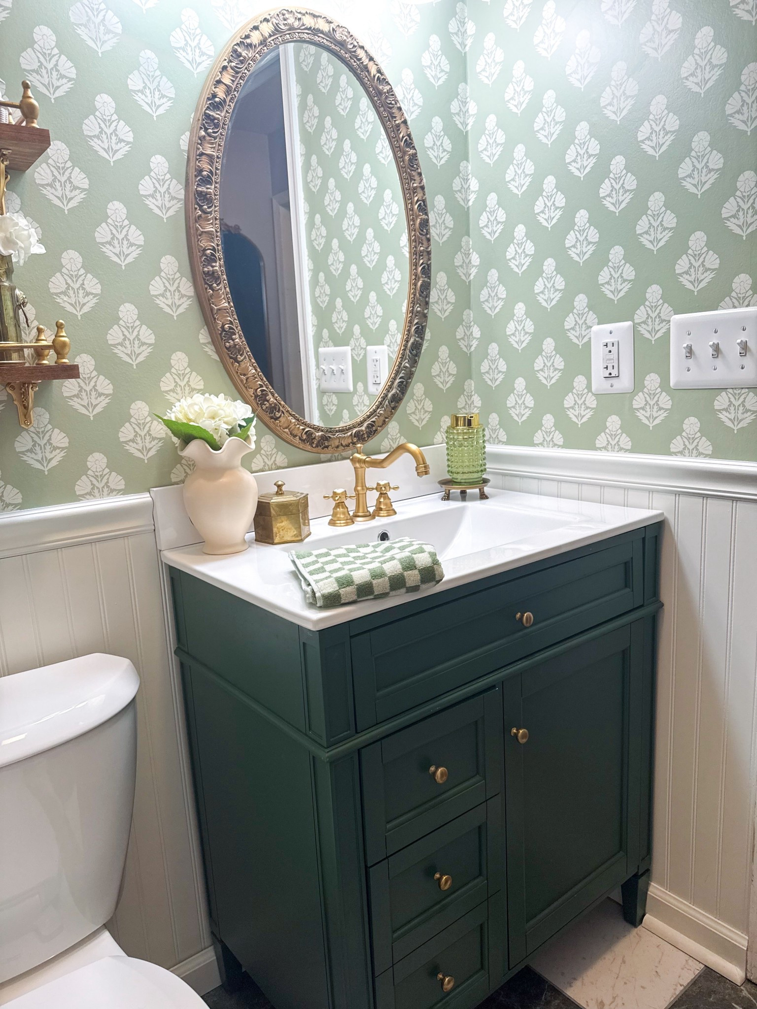 This vanity completely changed the feel of this space 🤍

A deep green bathroom vanity is one of those pieces that instantly makes a room feel custom and elevated. I love how the rich color grounds the space while still feeling soft and timeless—especially paired with warm brass hardware and a classic white top. It adds storage without looking bulky, and the drawer + cabinet combo makes it actually functional for everyday use (which is rare for smaller bathrooms).

If you’re trying to make a builder-grade bathroom feel more high-end, this is the upgrade that does the heavy lifting. It’s one of those pieces that looks like it came from a custom renovation… but without the custom price.

#bathroomvanity #greenvanity #bathroomupgrade #cozyhome #vintageinspired #collectedhome #homedecorfinds #ltkhome