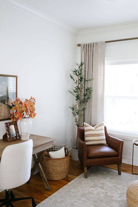 A cozy corner perfect for fall!
Fall decor 
Fall greenery 
Home office
Baskets
Leather armchair 
Throw pillows 
Wood campaign desk 
Pottery Barn curtains 
Window coverings 

#LTKhome #LTKSeasonal #LTKstyletip