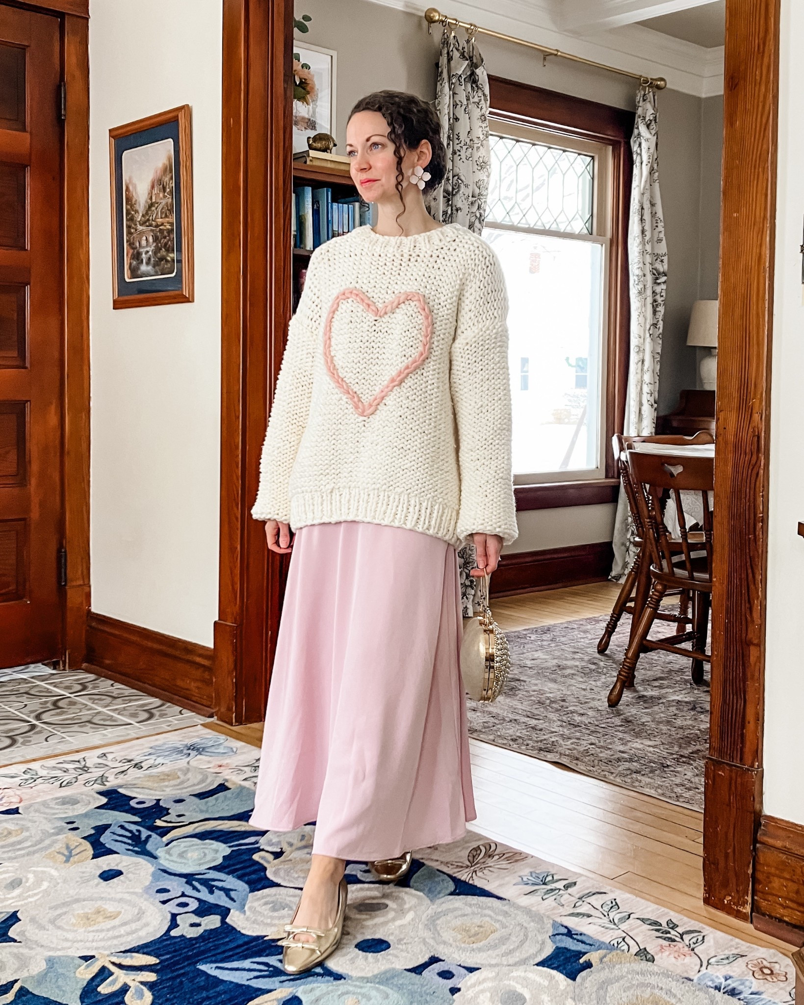 A pretty cream and light pick outfit for Valentine’s Day!
Chunky cream sweater with heart from Chicwish. 
Light pink skirt from Chicwish. 
Large pink flower earrings are old, linking similar. 
Gold pearl heart bag from Chicwish. 
Gold leather ballet flats from C.Paravano. 
Petite outfit. Modest outfit. Valentine’s Day outfit. Cute outfit  

#LTKValentine #LTKOver40 #LTKgrwm