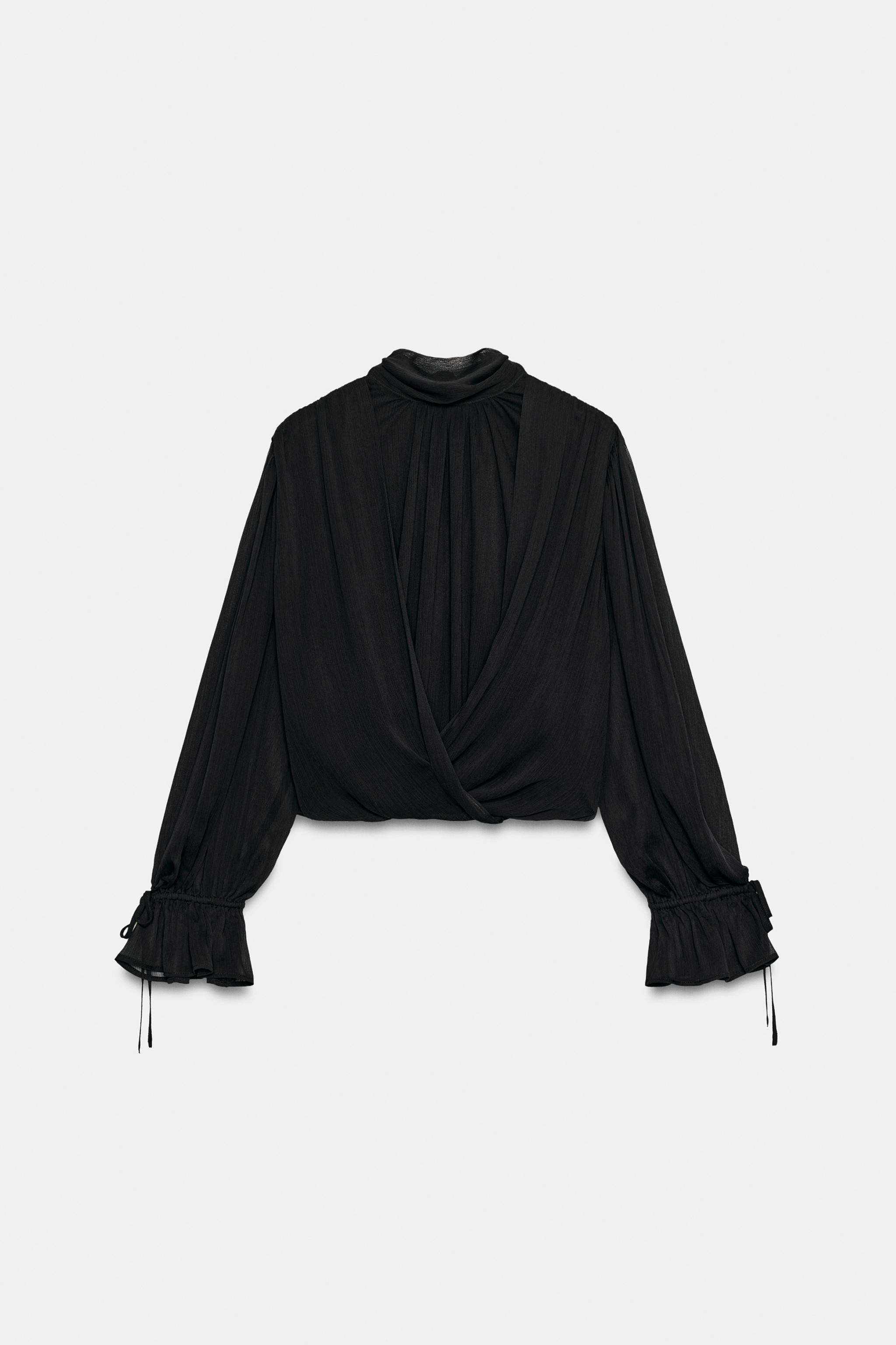 High neck top with long sleeves featuring elastic cuffs with ties. Interior back lining. Hem with... | Zara UK