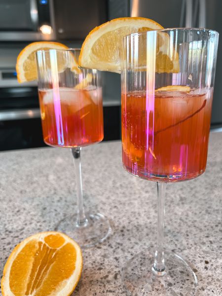 Let’s create a mama mocktail with these gorgeous glasses from @joyjolt! #ad. I love a good mocktail as a breastfeeding mom but I always want to elevate it with a gorgeous glass. I found the perfect ones! These glasses have an iridescent finish that adds a classy touch to any beverage.
.
To make this mocktail I used: 
•JoyJolt Christian Siriano New York Chroma Iridescent White Wine Glasses
•Olipop Orange Squeeze
•Splash of Cherry syrup 
•Cherries and oranges to garnish

Cheers! 
#JoyJoltPartner #JoltOfJoyHolidays #joyjoltmoments

#LTKparties #LTKhome