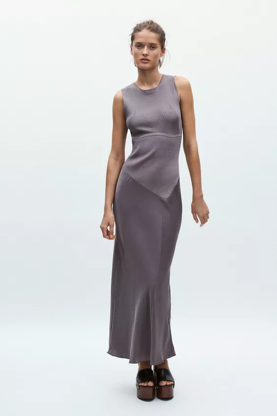 Long sleeveless dress with a round neck. Satin fabric hem detail. Back opening with hidden button... | Zara US