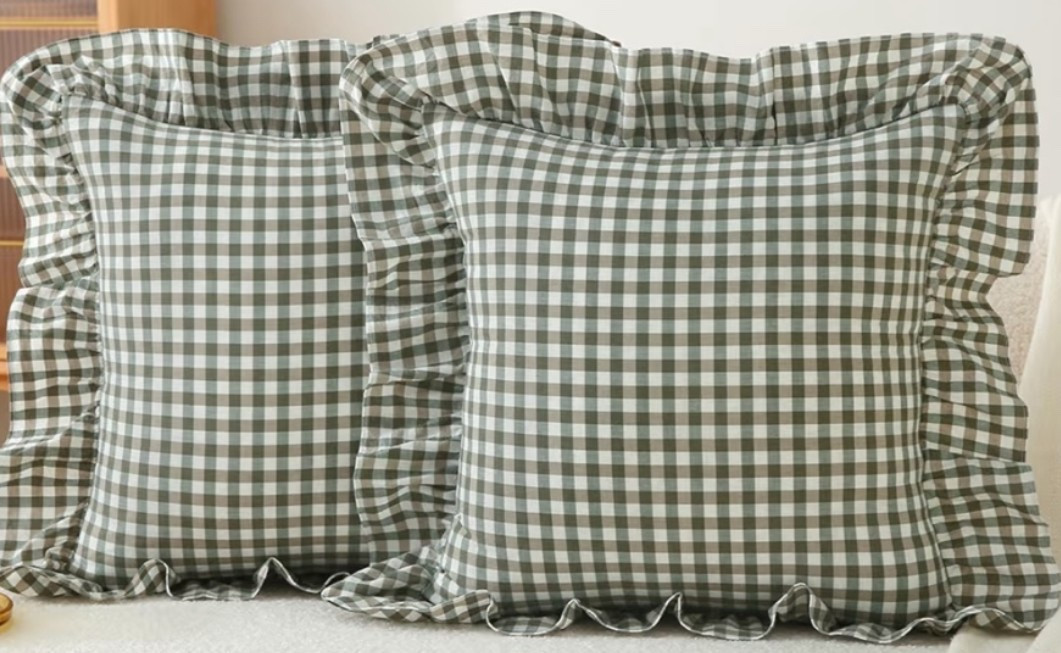 Sage green gingham pillow covers with that cozy cottage farmhouse feel that makes a bed, sofa, or reading nook look instantly softer and more inviting. 🍎 Perfect for a living room, bedroom, guest room, nursery, porch swing, or summer home refresh when you want warm texture and a little vintage-inspired detail. The washed cotton fabric, ruffle trim, and checkered pattern give them that relaxed countryside look without feeling too busy. 

Add this set if your space needs a softer layer with cozy cottage warmth. 🌿🪿

#LTKOver40 #LTKHome #LTKSeasonal