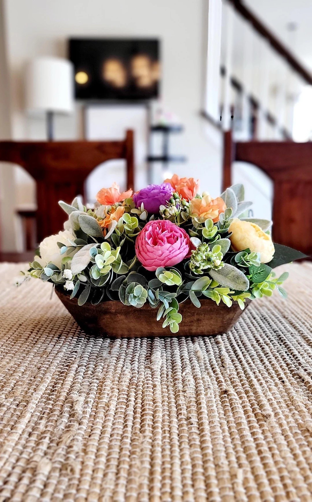 Made with love ❤️, this hand-carved dough bowl centerpiece from JuliasTreasuresStore is a true statement piece for spring and beyond. Overflowing with lush silk peonies in soft creams and cheerful pops of pink, purple, yellow, and orange, plus realistic greenery and lambs ear, it brings warm farmhouse charm to your table, mantel, or kitchen island. Measuring an impressive 19” long and shipping from New Jersey (shorter shipping distances are kinder to the planet 🌿), this vibrant faux floral arrangement makes a thoughtful gift for her, a beautiful wedding centerpiece, or an easy way to refresh your home with lasting color. Custom options are available for a personalized touch.

#LTKhome #FarmhouseDecor #SpringCenterpiece #DoughBowlDecor #PeonyDecor #EtsyFinds #HomeStyling #MantelDecor #KitchenIslandDecor #SustainableShopping

#LTKHome #LTKSeasonal #LTKWedding