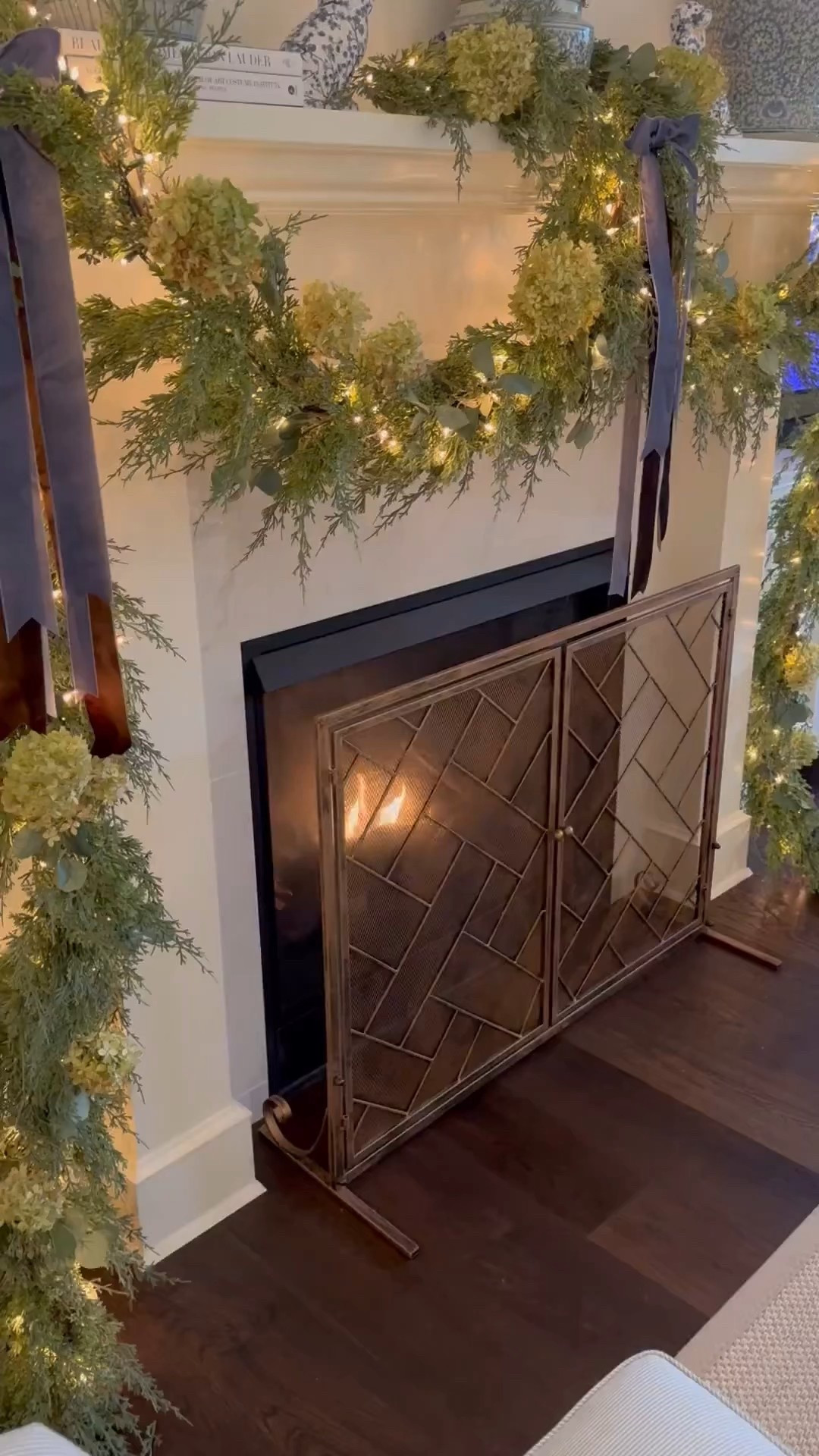 There’s just something about the glow of the fire and the scent of pine that makes everything feel a little calmer. The lights, the garland, it all comes together to make the house feel extra cozy this time of year.

#LTKHome