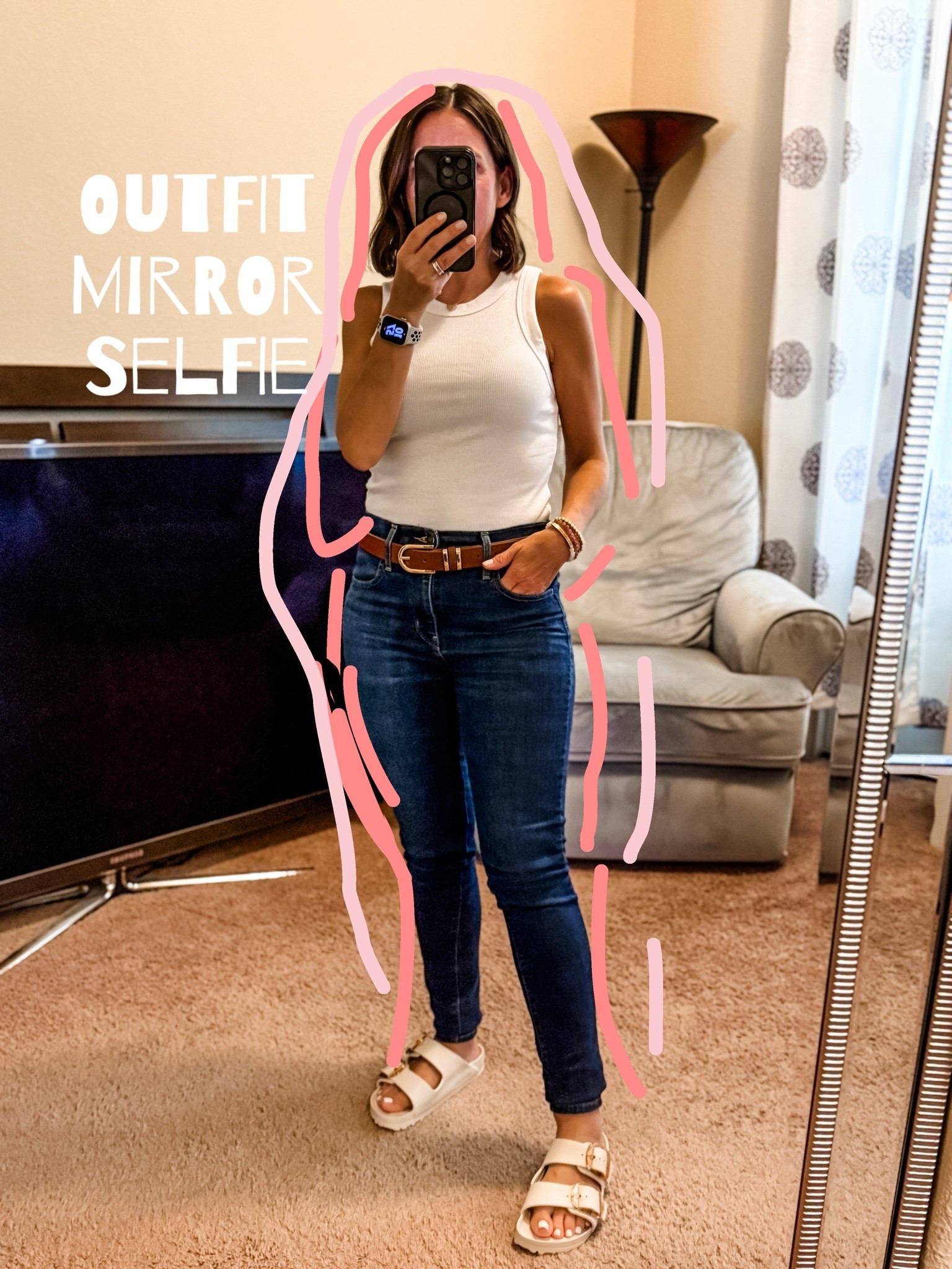 Mirror Selfie of one of my favorite summer outfits. This includes all my faves. A cute tank top that fits just right. Btw go with your true size. 
Levi’s jeans because they fit so good and make the bum look amazing. 
Brown leather belt because it’s a classic. Plus I’m petite. So defining the waist is a good thing. 
Birkenstocks that are water resistant. Yes please. 
Petite outfit 
Petite style

#LTKOver40 #LTKPetite #LTKSaleAlert