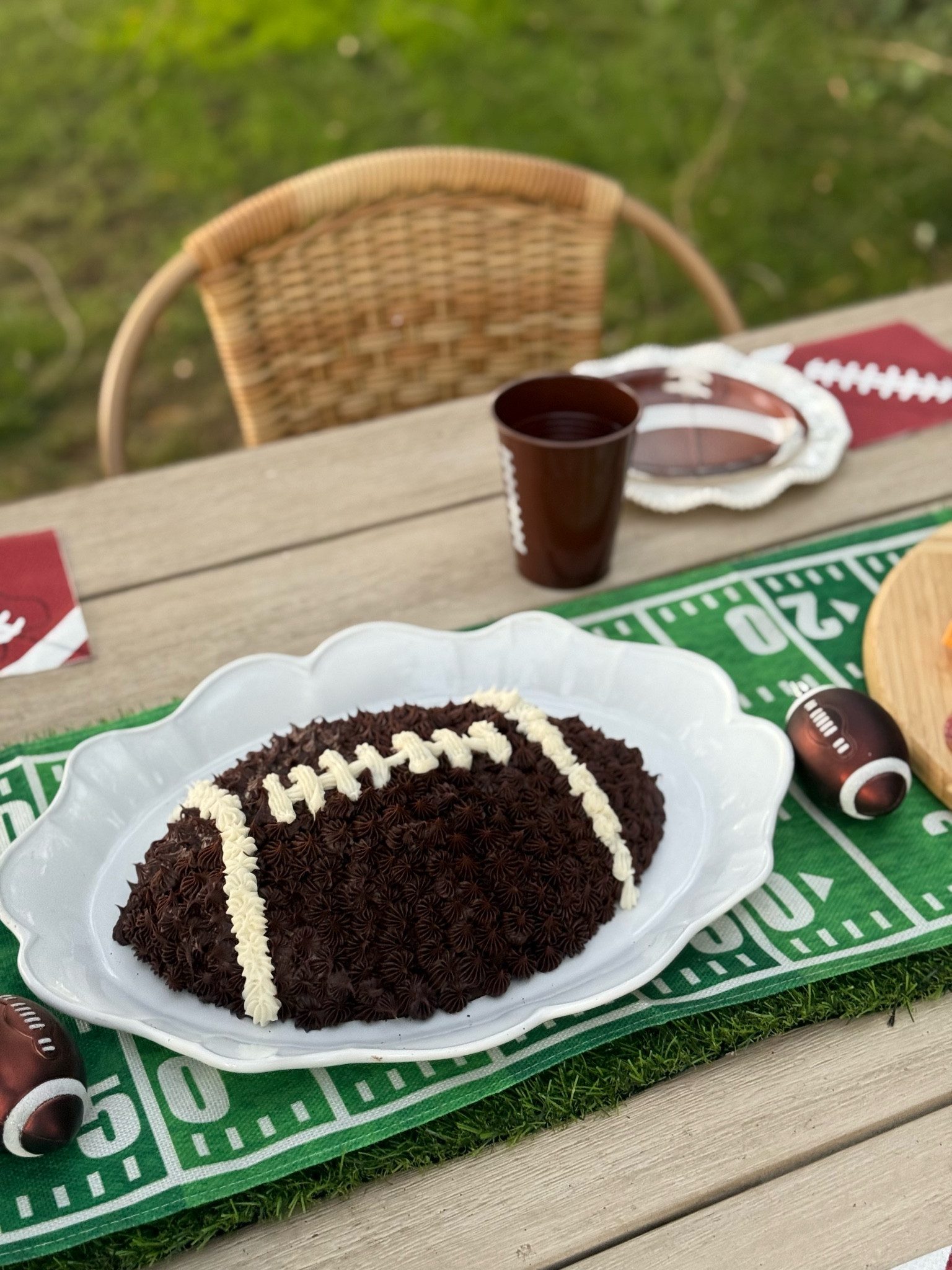 Super Bowl finds!! Super Bowl party entertaining must haves. This football shaped cake pan is a must and is perfect for the big game. Love this Touchdown table runner. I added a faux grass table runner underneath for texture! Football plates. Football cups. Football napkins. Football decor. Super Bowl decor. 🏈❤️ 

#LTKHome #LTKParties #LTKSeasonal
