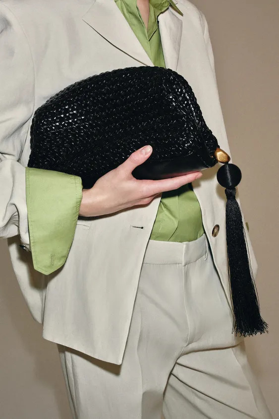 Braided pouch bag with a patent finish. Tassel with metal detail. Interior zip pocket. Magnetic c... | Zara UK