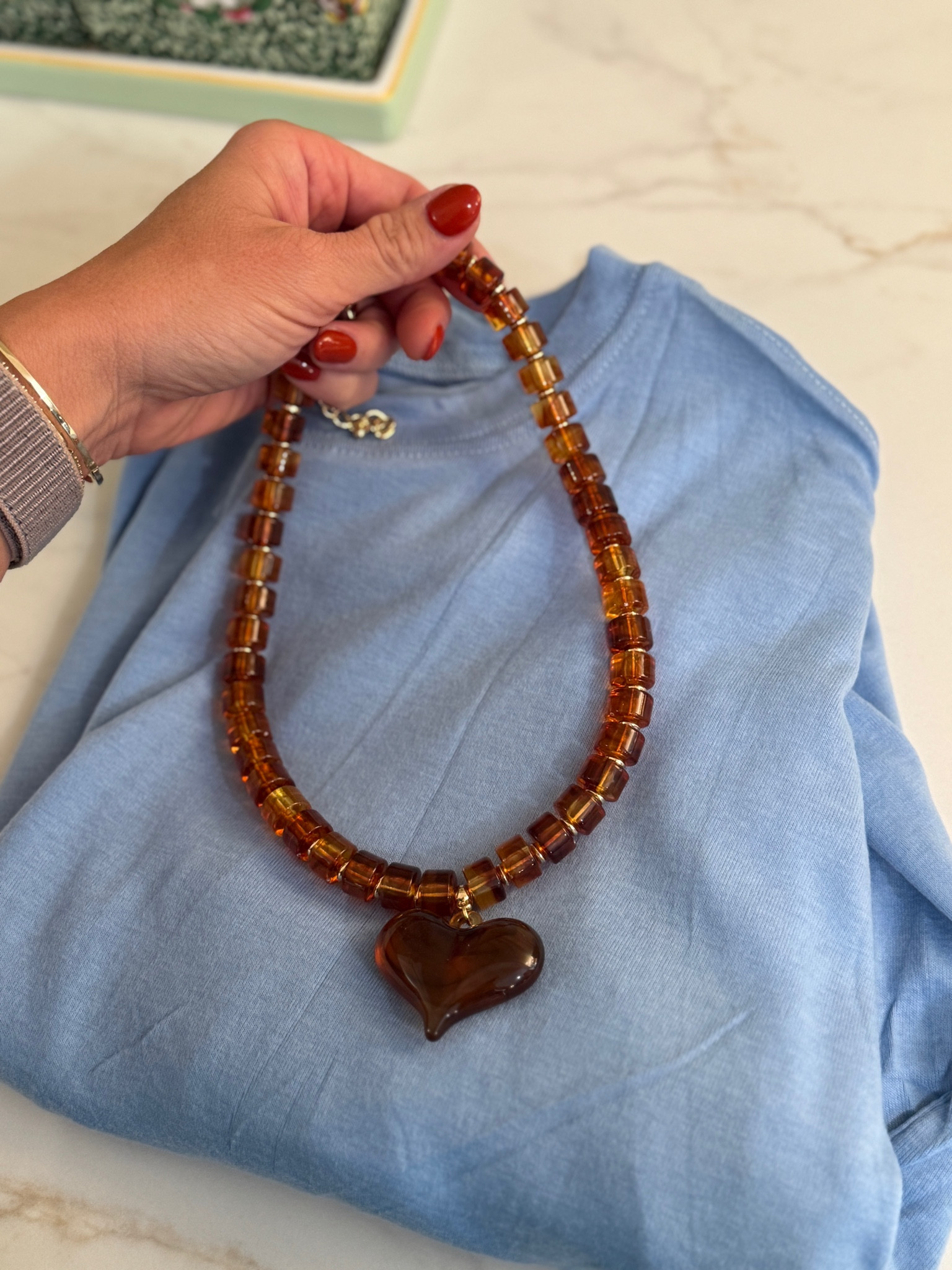 You won’t believe the price of this necklace. I’ve seen this same necklace for $100. 

Heart necklace 
Beaded necklace 

Amazon
HOC Autumn