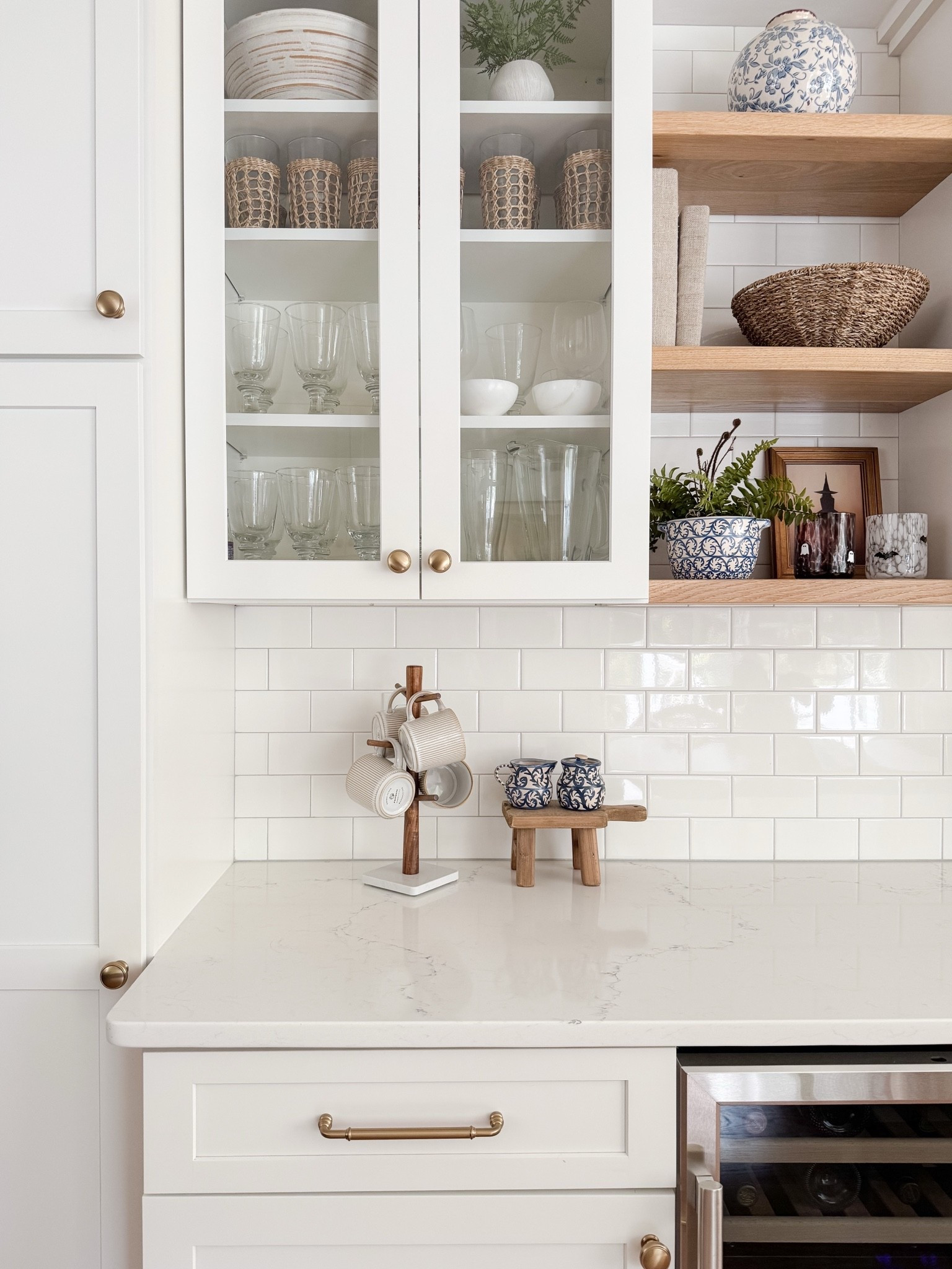 Built in cabinet styling with soft neutrals, glass fronts, and warm wood shelving that adds texture without clutter. This cape cod coastal kitchen keeps everything light, layered, and beautifully organized. Cape cod kitchen, coastal kitchen cabinets, glass cabinet styling, neutral kitchen decor, open shelf kitchen styling, amazon finds home decor, coastal neutral kitchen, sherri calnan home

#LTKHome