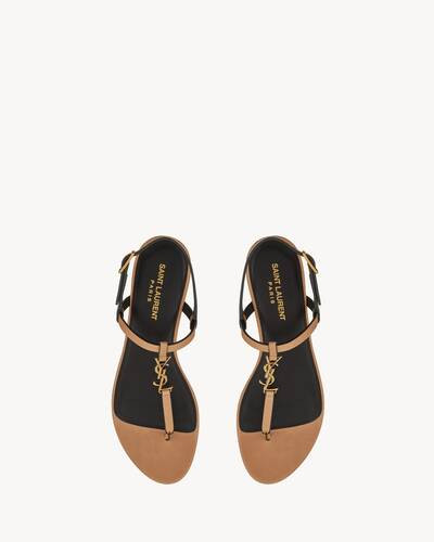 Flat sandals with a t-strap arch band and an adjustable buckle, decorated with metal CASSANDRE on... | Saint Laurent Inc. (Global)